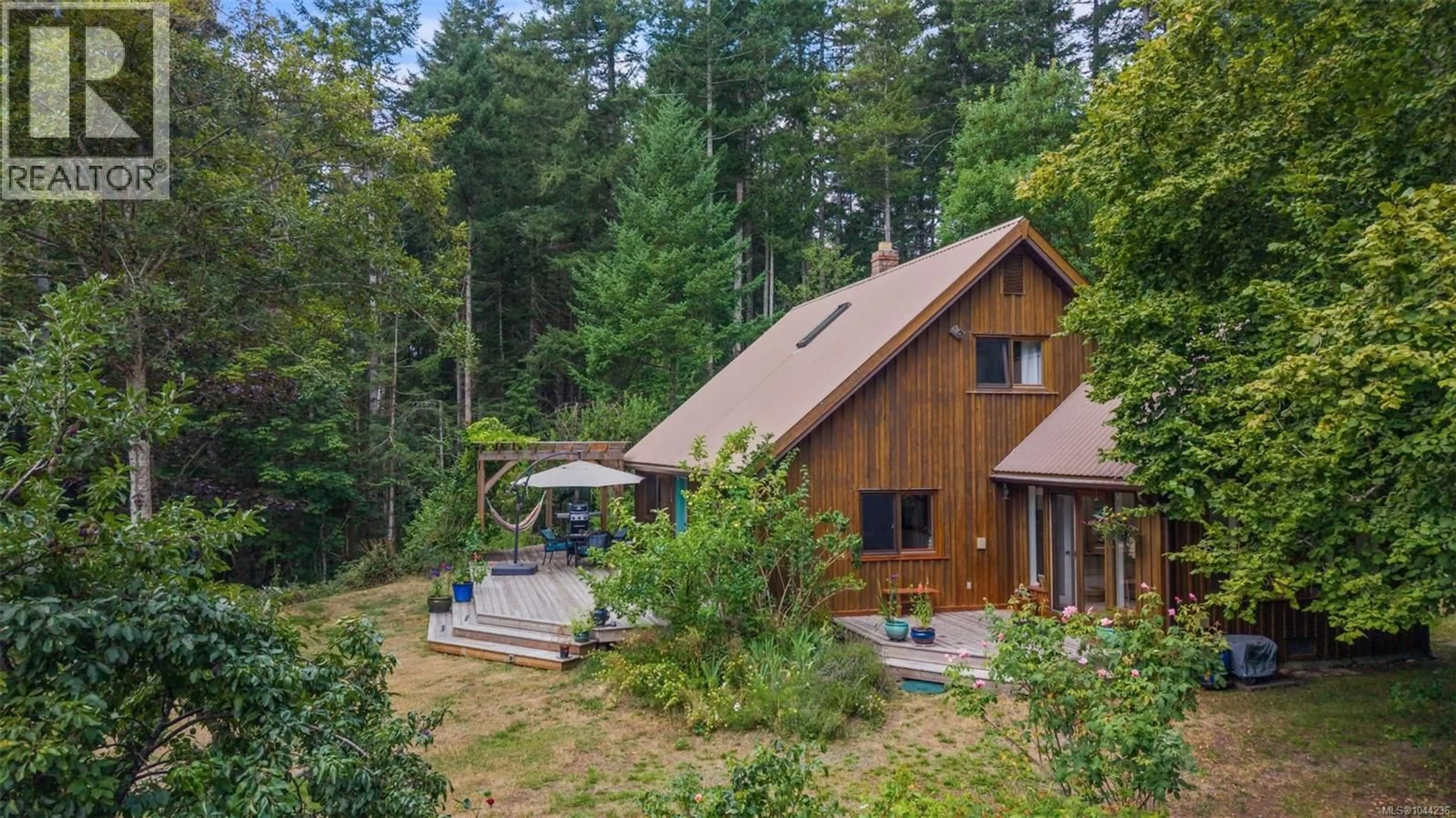 A pic from outside/outdoor area/front of a property/back of a property/a pic from drone, forest/trees view for 1551 PICKLES ROAD, Denman Island British Columbia V0R1T0