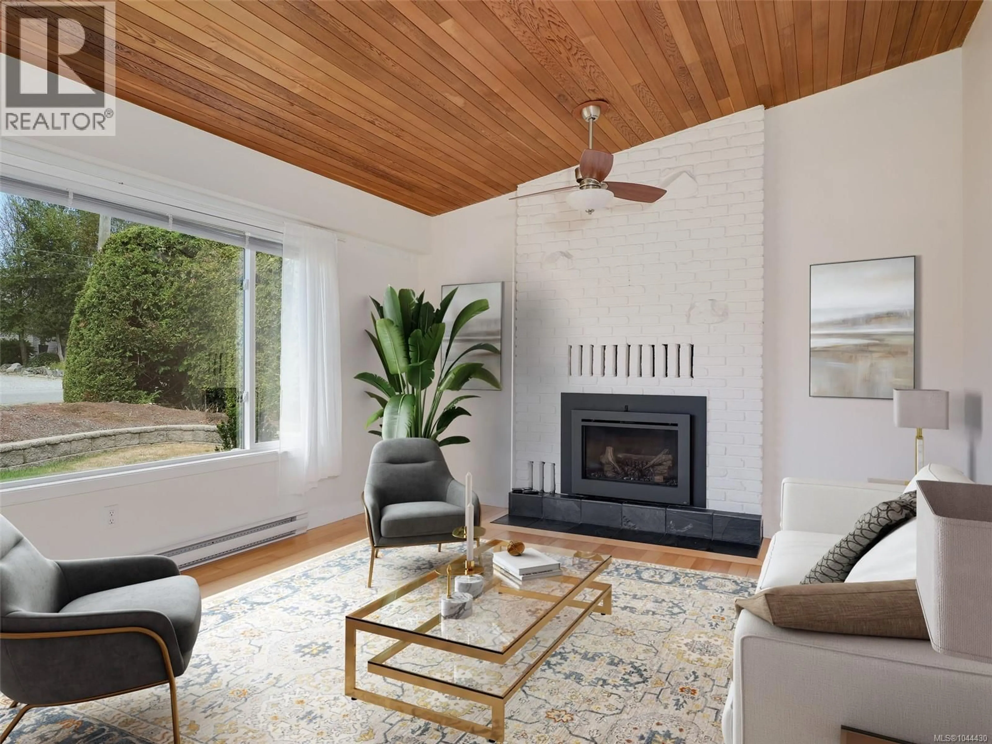 Living room with furniture, wood/laminate floor for 7927 WALLACE DRIVE, Central Saanich British Columbia V8M1L4