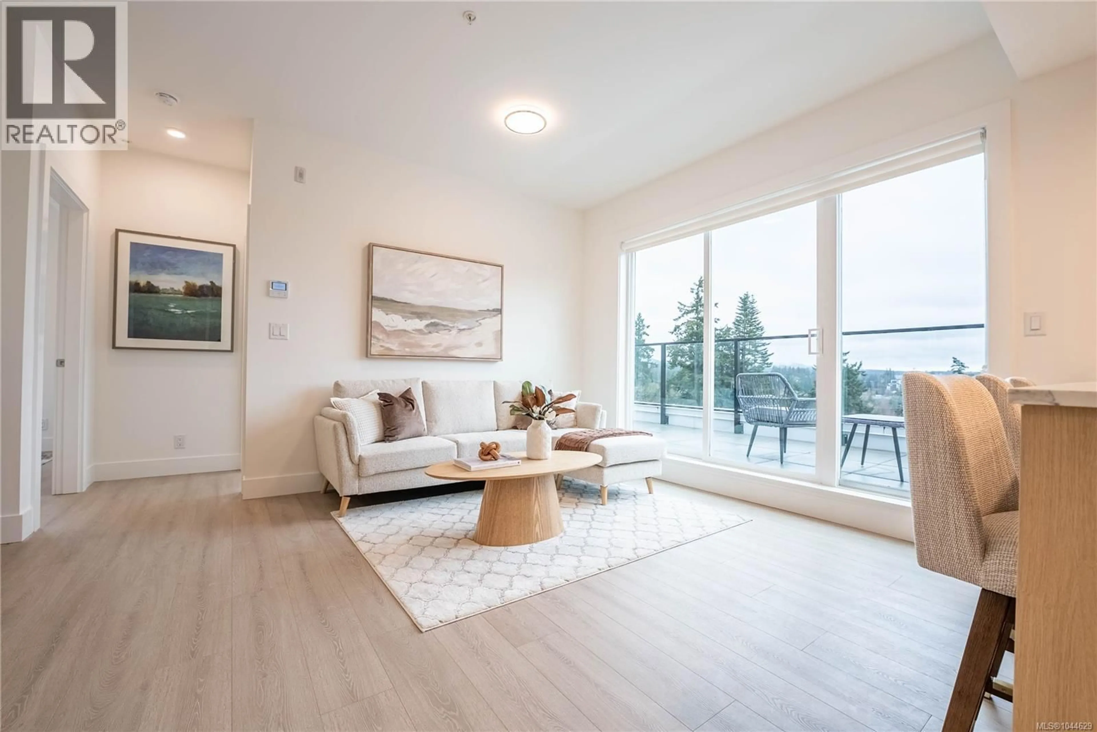 Living room with furniture, wood/laminate floor for 412 - 258 HELMCKEN ROAD, View Royal British Columbia V9B7G9