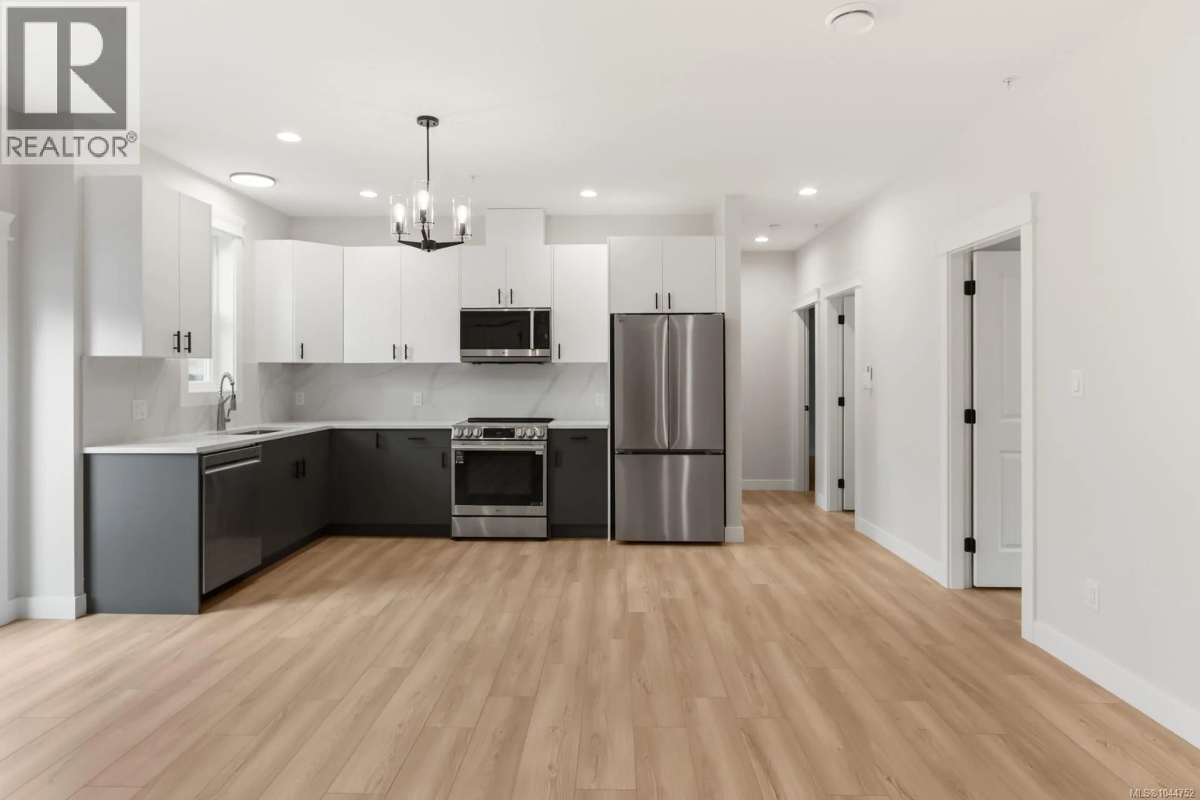 Open concept kitchen, wood/laminate floor for 200 - 2190 JINGLE POT ROAD, Nanaimo British Columbia V9R6J2