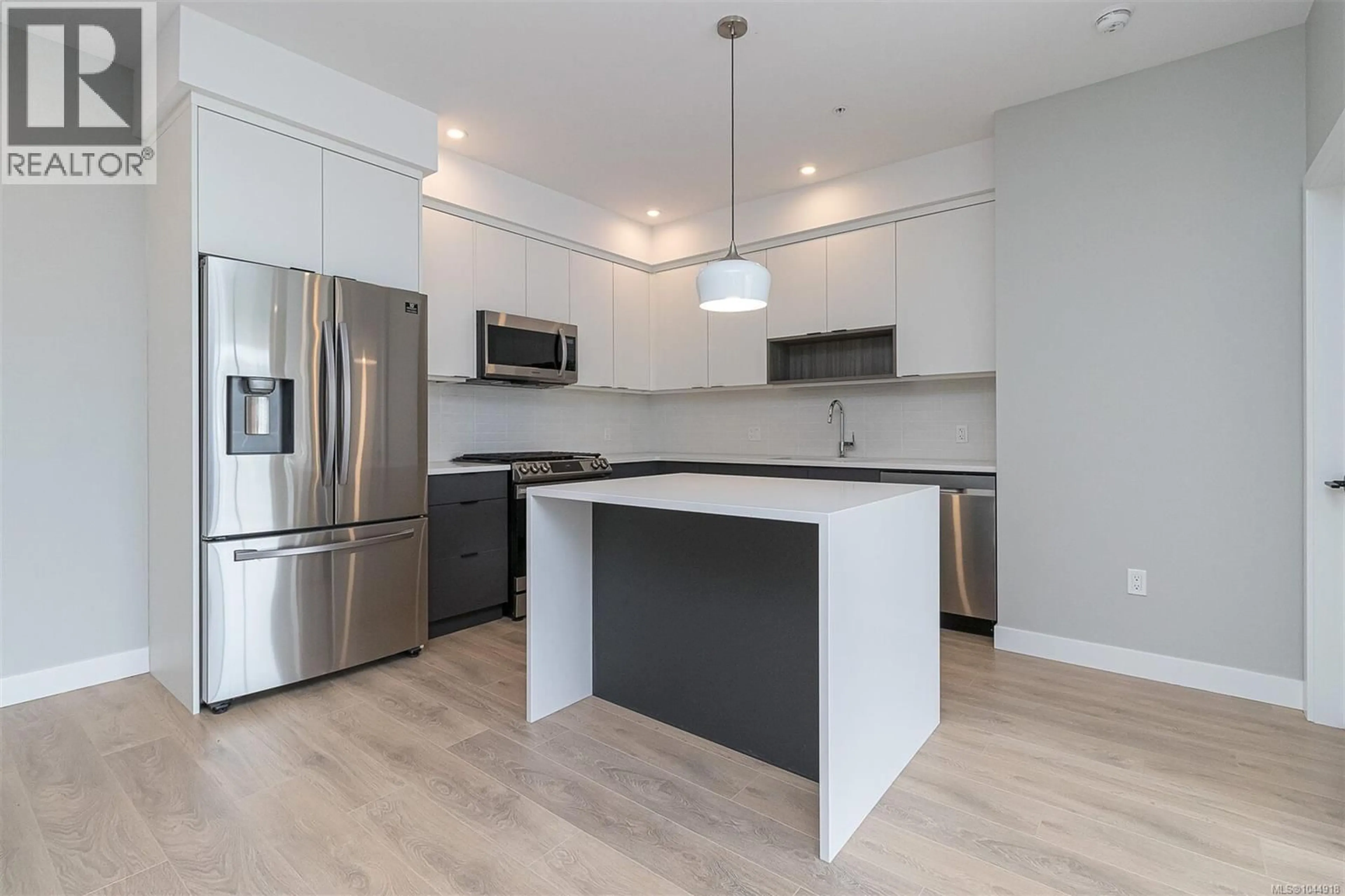 Open concept kitchen, wood/laminate floor for 606 - 967 WHIRLAWAY CRESCENT, Langford British Columbia V9B6W6