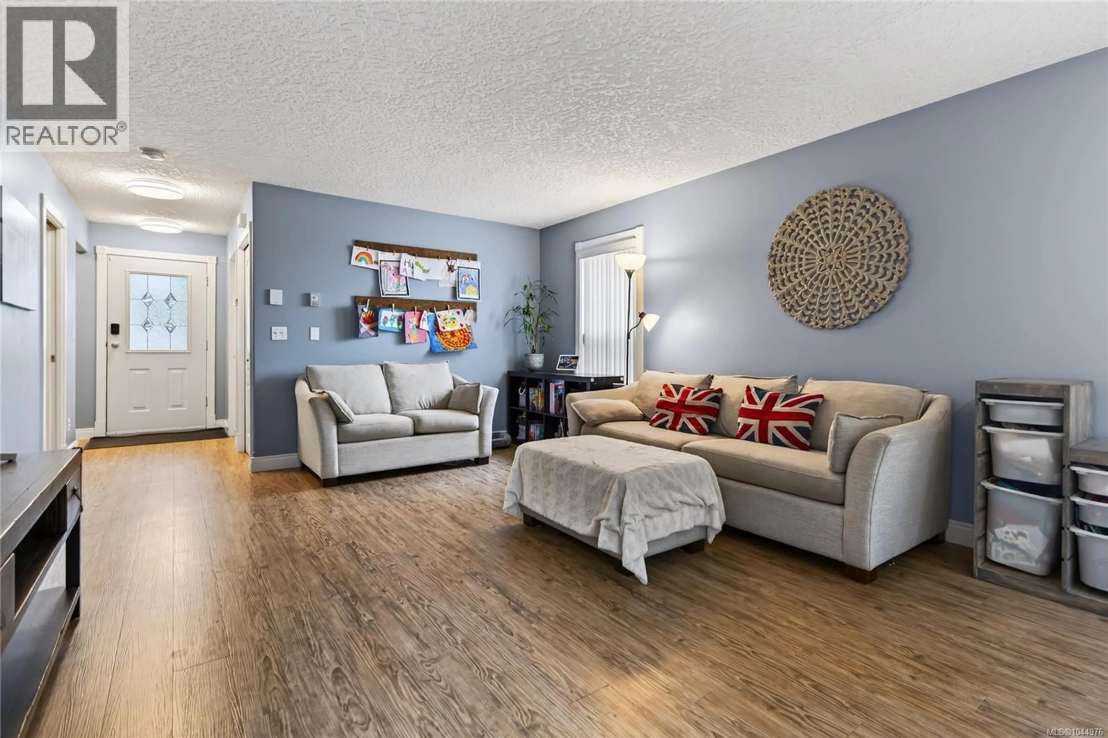 Living room with furniture, wood/laminate floor for A - 1820 1ST STREET, Courtenay British Columbia V9N6V5