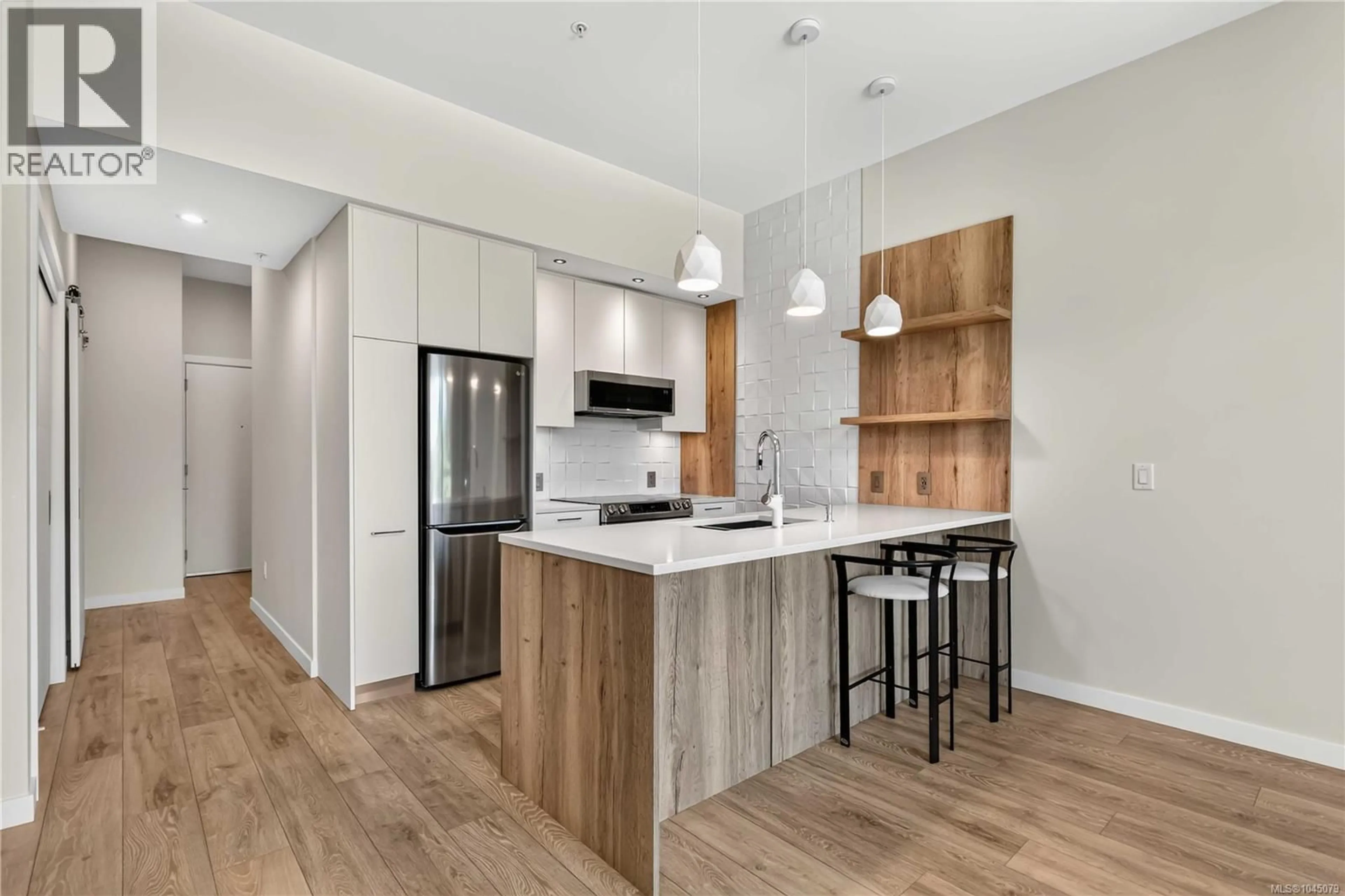 Open concept kitchen, wood/laminate floor for 415 - 1588 NORTH DAIRY ROAD, Saanich British Columbia V8T3V4