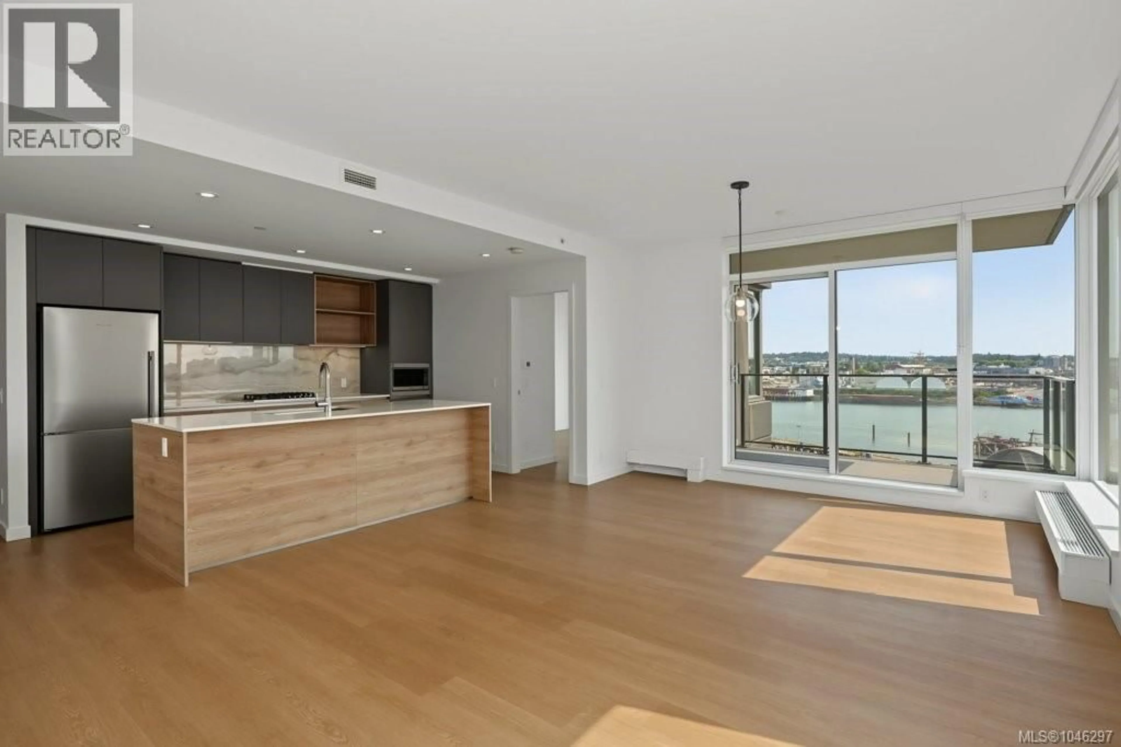 Open concept kitchen, wood/laminate floor for 609 - 363 TYEE ROAD, Victoria British Columbia V9A0B5