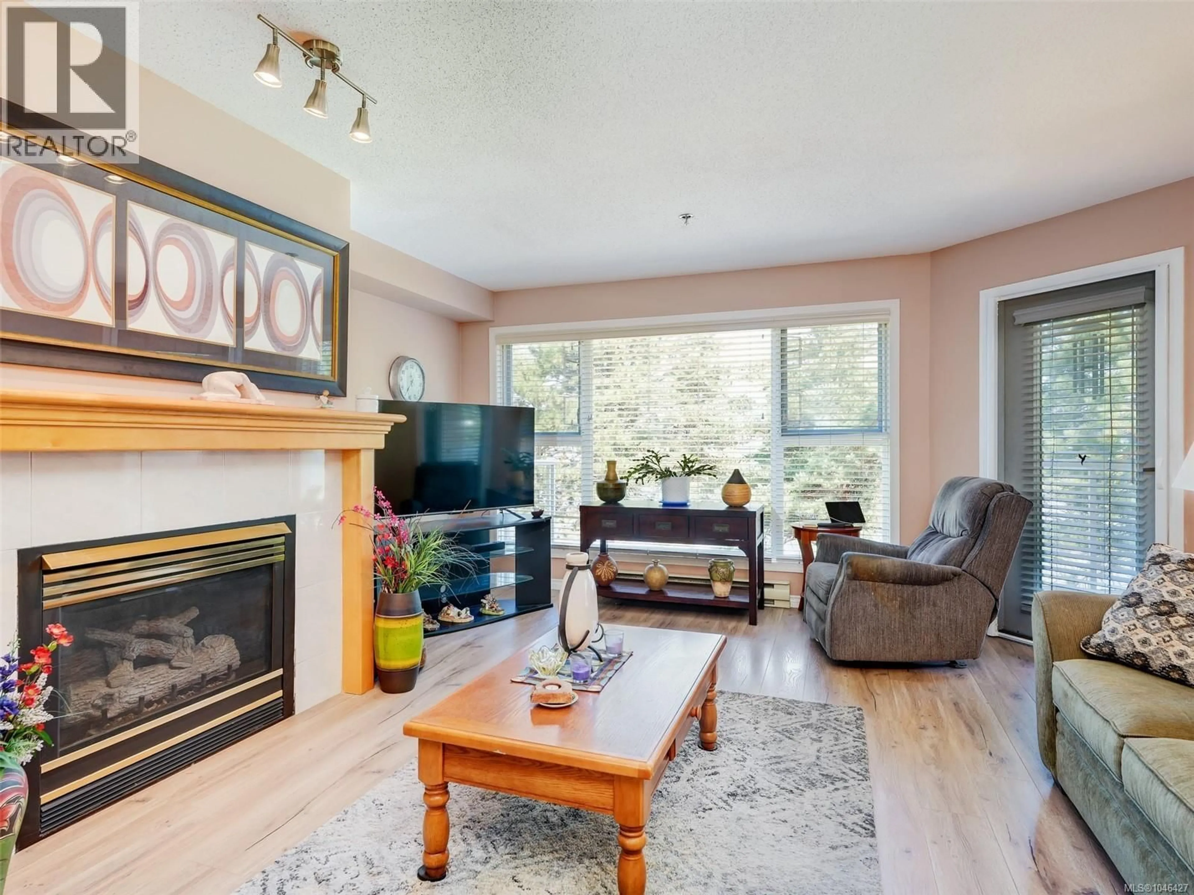 Living room with furniture, wood/laminate floor for 305 - 3009 BRITTANY DRIVE, Langford British Columbia V9B2N7