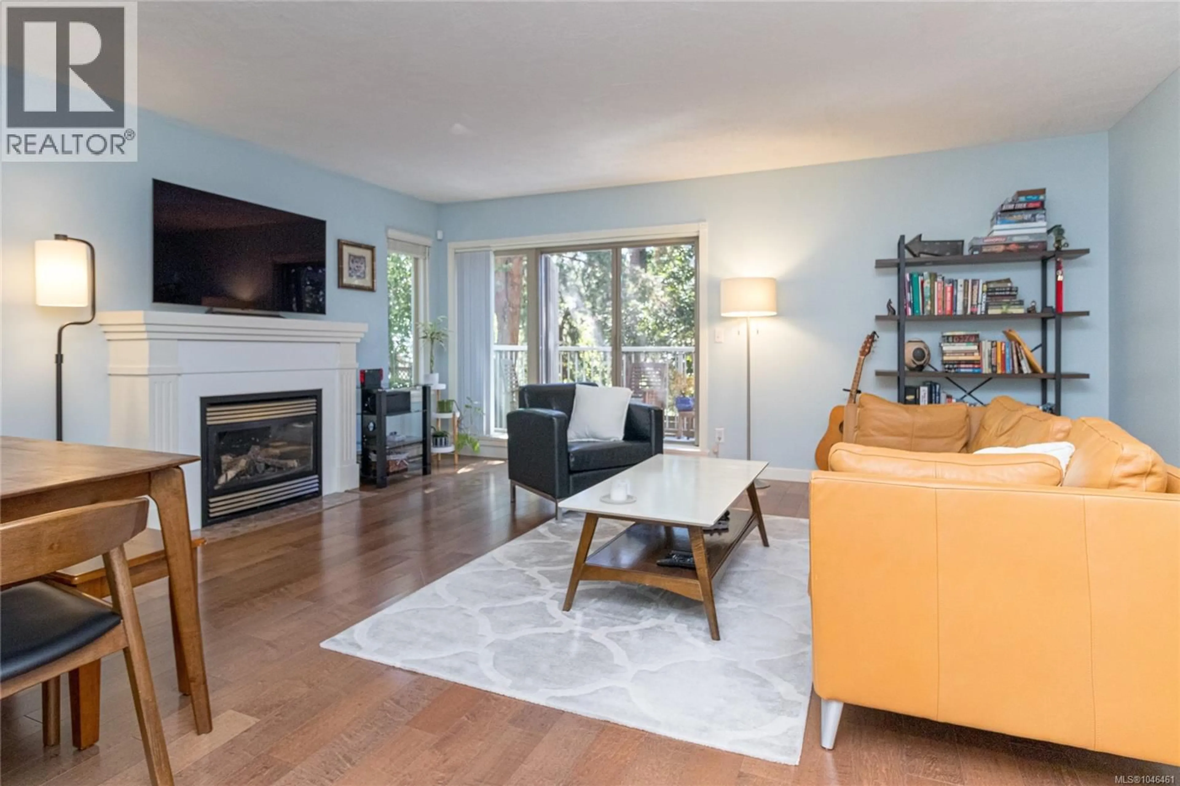 Living room with furniture, wood/laminate floor for 208 - 3880 QUADRA STREET, Saanich British Columbia V8X1H8
