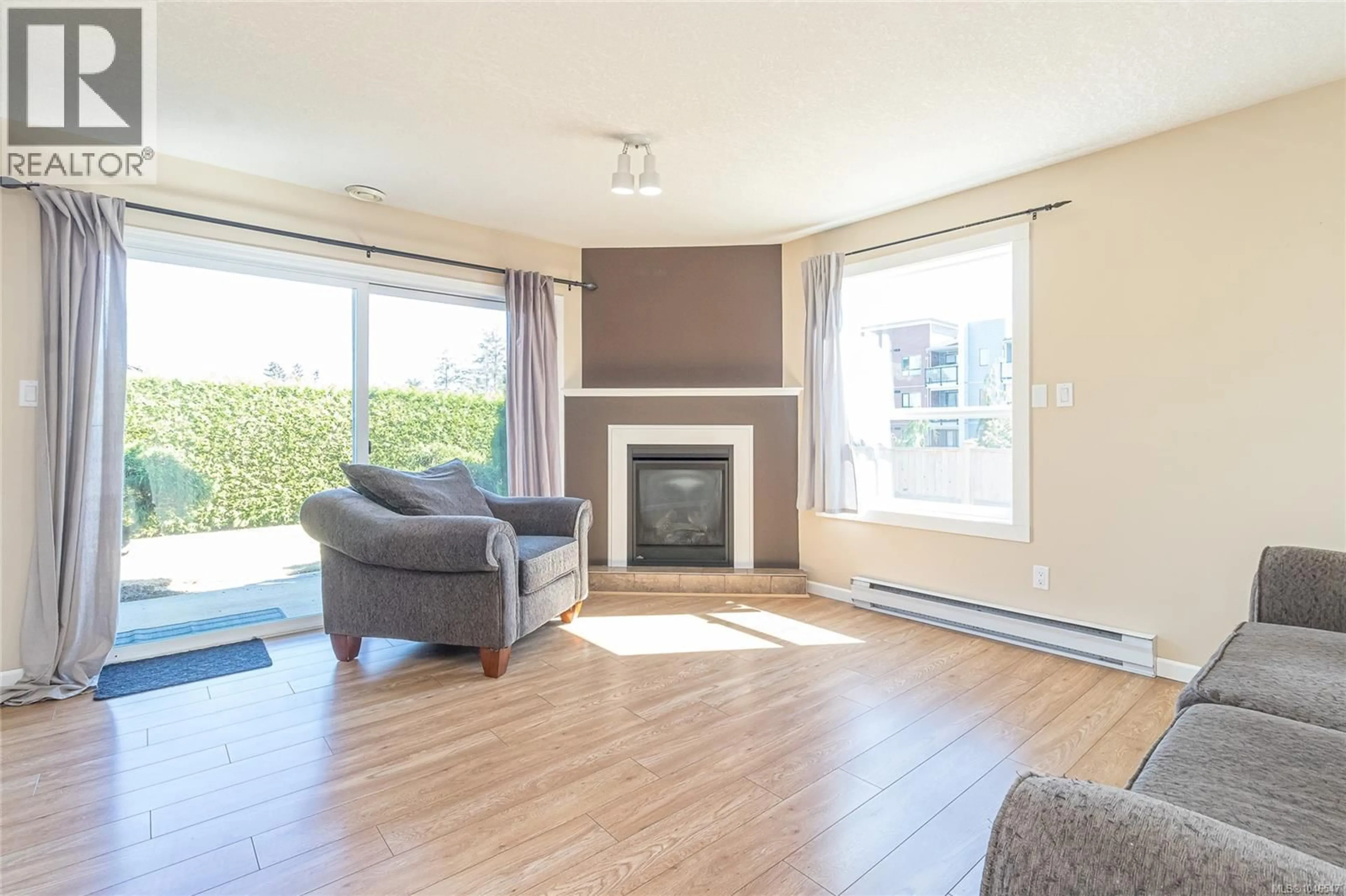 Living room with furniture, wood/laminate floor for 104 - 435 MORISON AVENUE, Parksville British Columbia V9P2M7