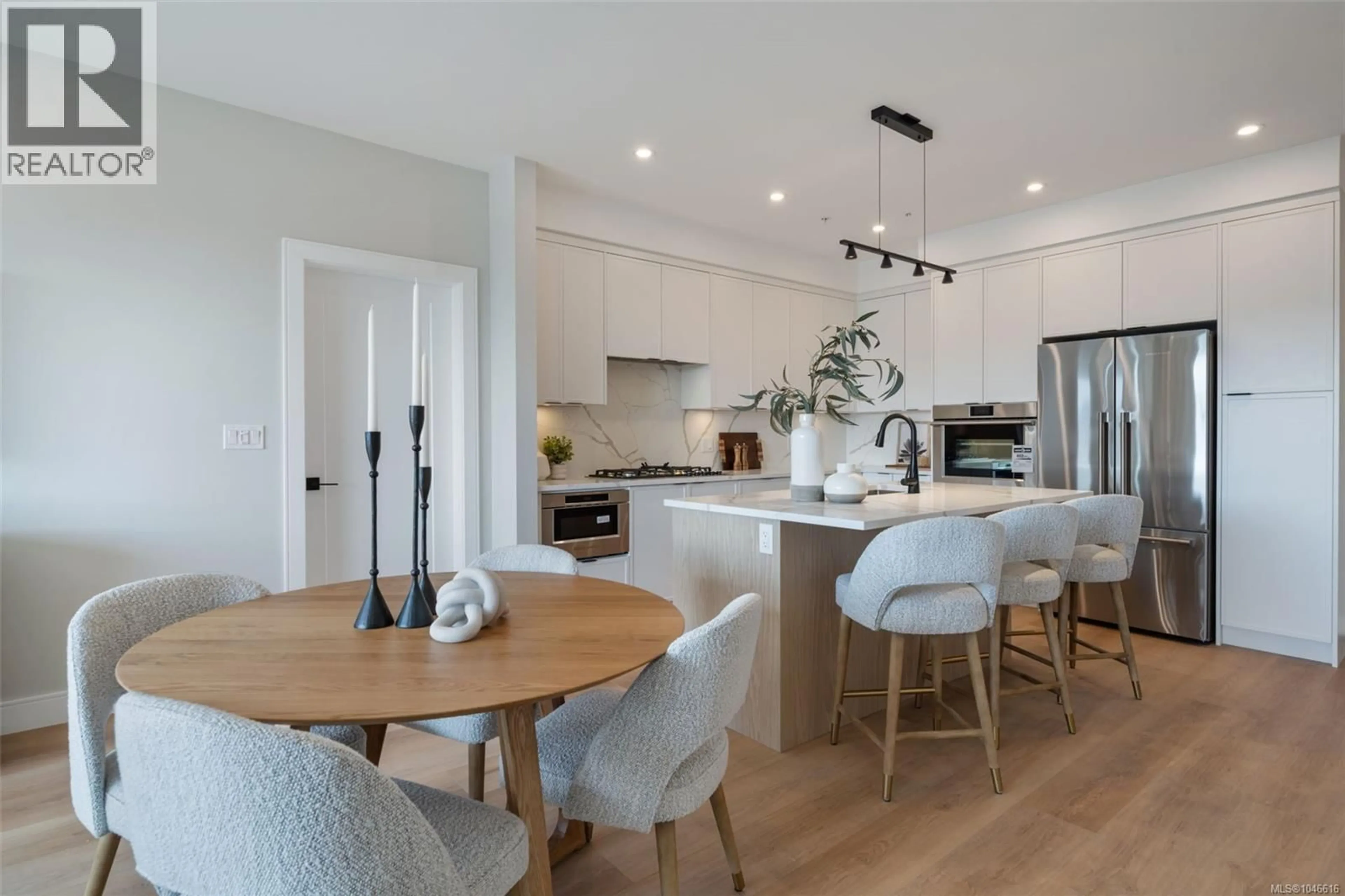 Open concept kitchen, wood/laminate floor for 603 - 1810 SELENITE PLACE, Langford British Columbia V9B7E2