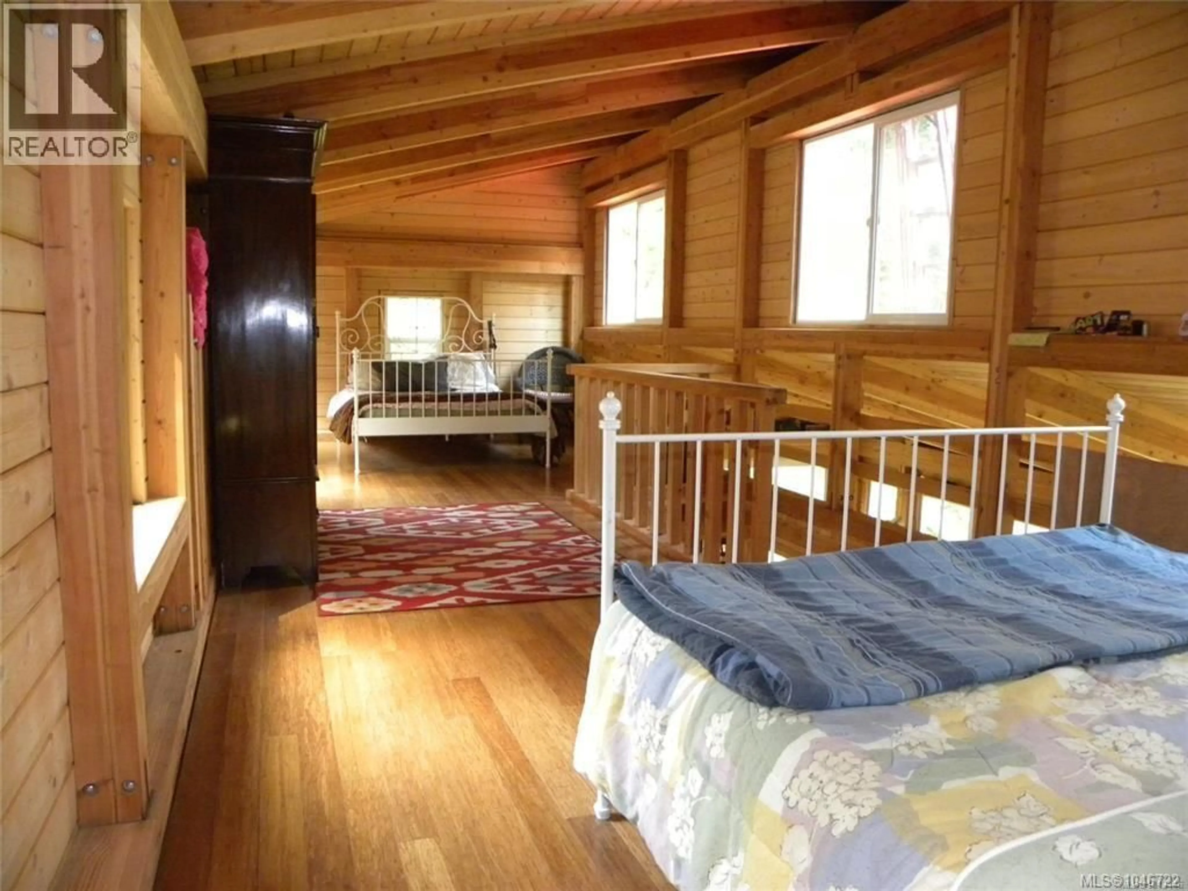 Bedroom with bed, wood/laminate floor for 66 SPRING BAY ROAD, Lasqueti Island British Columbia V0R2J0