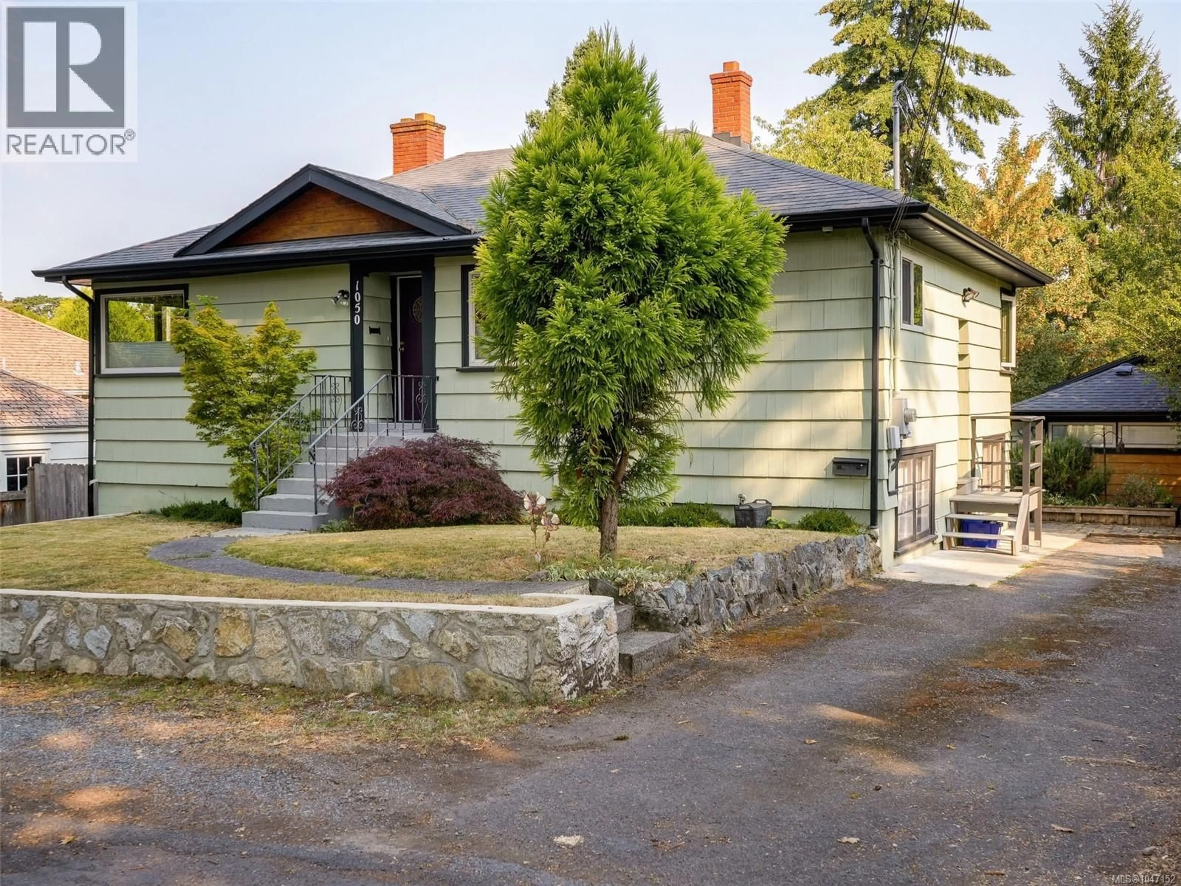 A pic from outside/outdoor area/front of a property/back of a property/a pic from drone, street for 1050 LESLIE DRIVE, Saanich British Columbia V8X2Y8