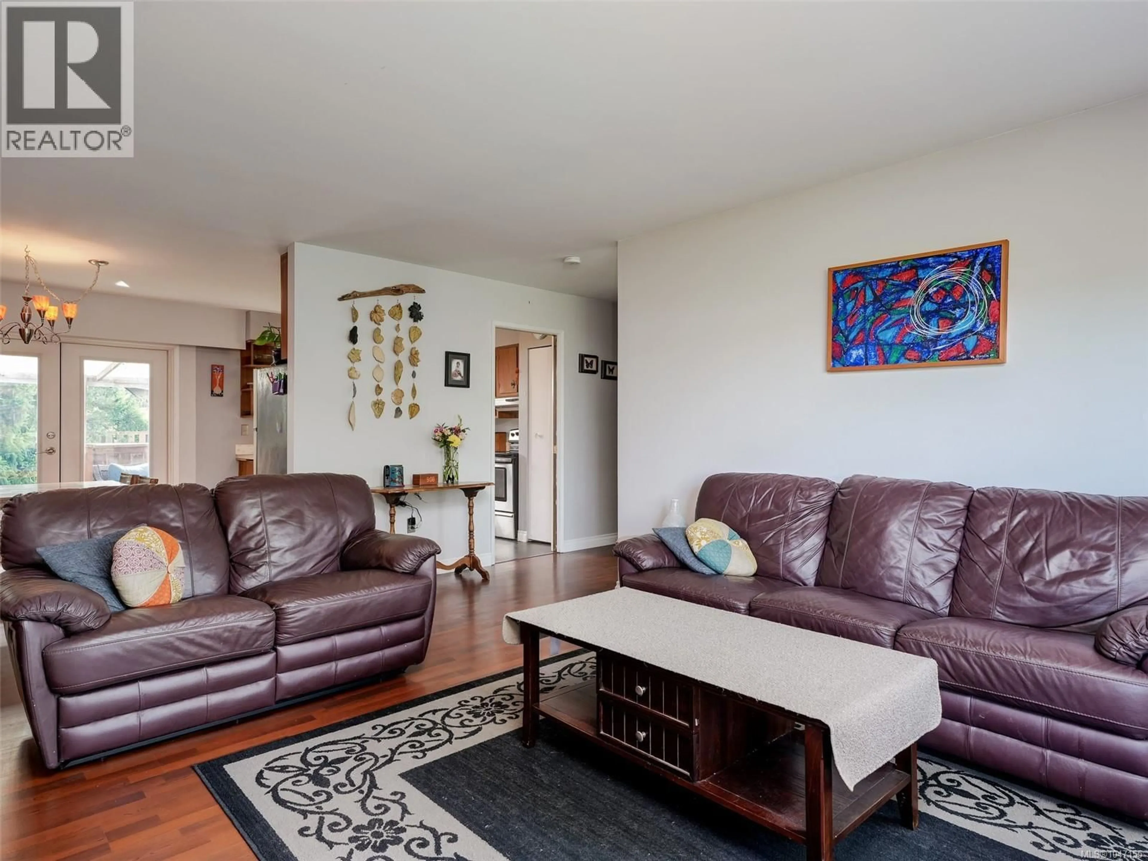 Living room with furniture, wood/laminate floor for 3941 LARCHWOOD DRIVE, Saanich British Columbia V8N5L5