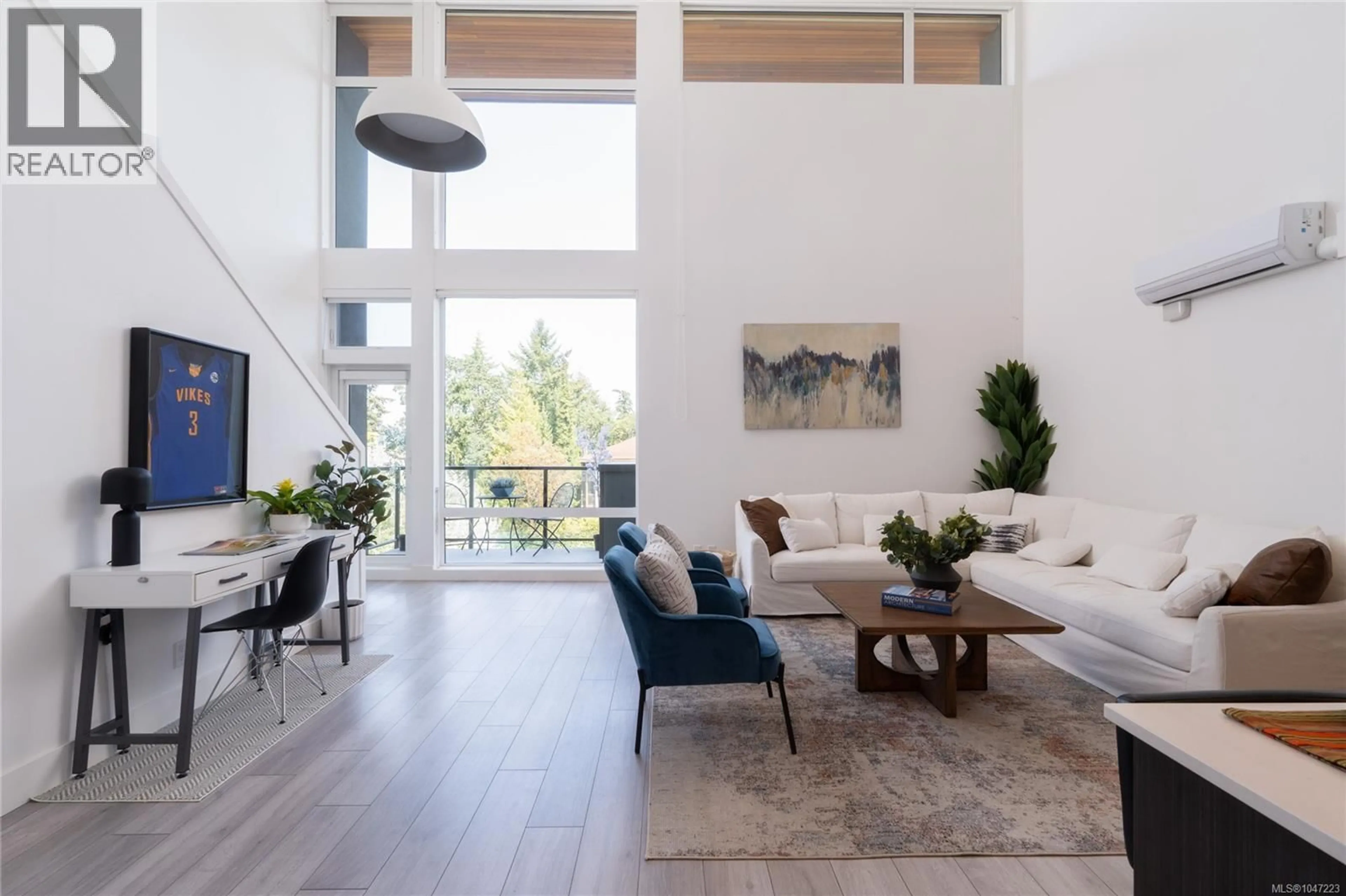 Living room with furniture, wood/laminate floor for 416 - 991 MCKENZIE AVENUE, Saanich British Columbia V8X3G8