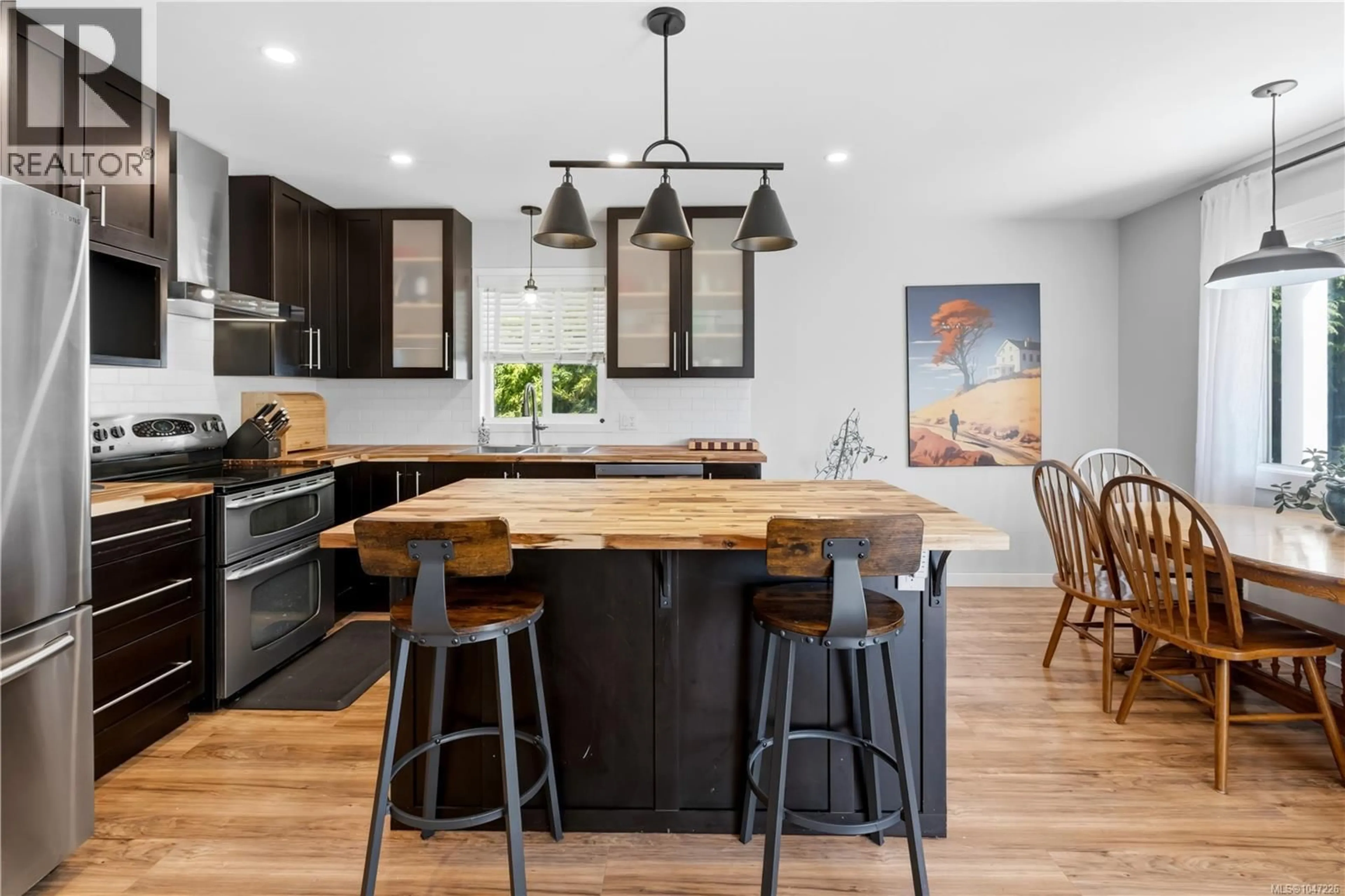 Open concept kitchen, wood/laminate floor for 1704 HOLLY CRESCENT, Ucluelet British Columbia V0R3A0