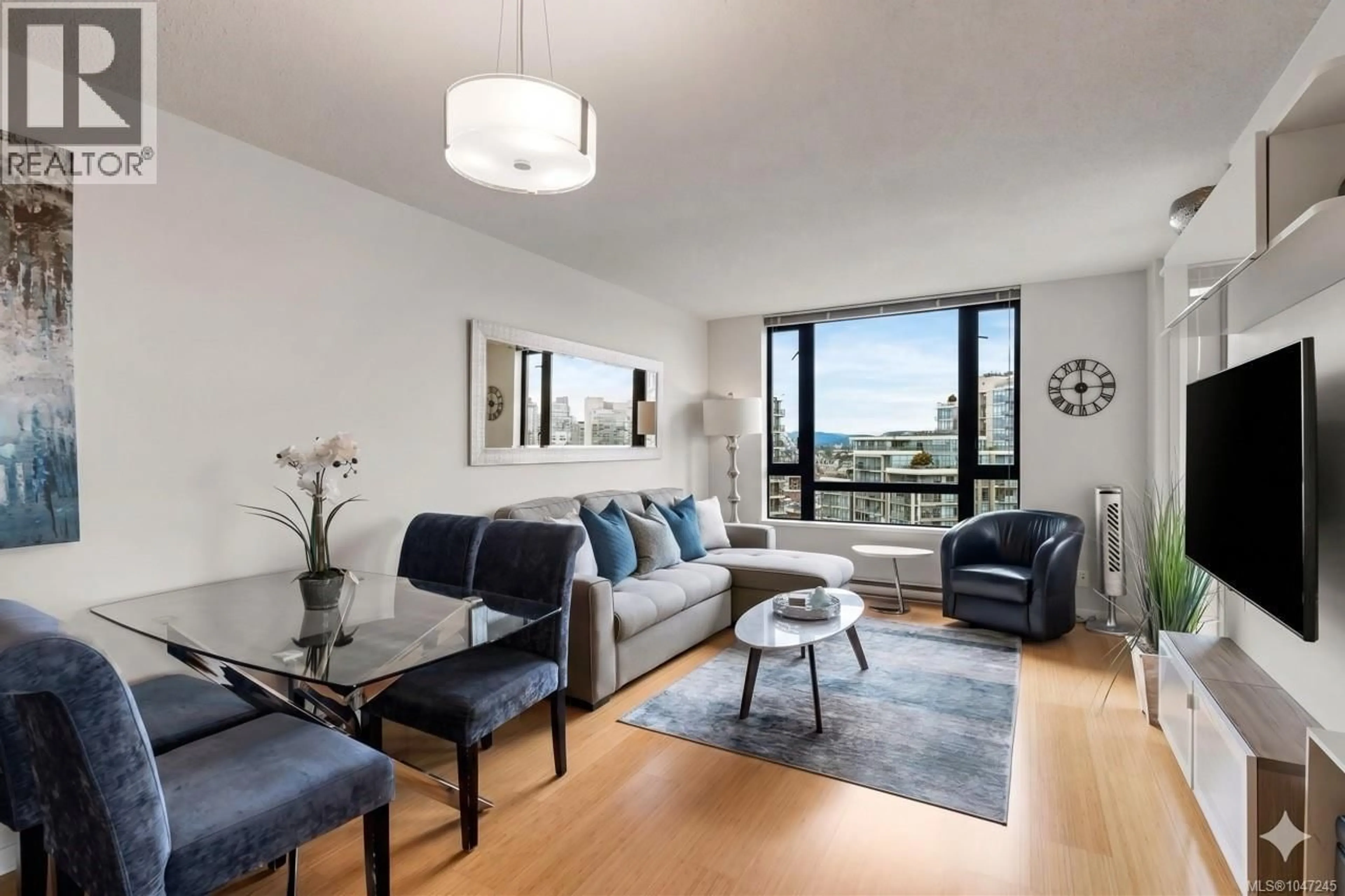 Living room with furniture, wood/laminate floor for 1502 - 751 FAIRFIELD ROAD, Victoria British Columbia V8W4A4