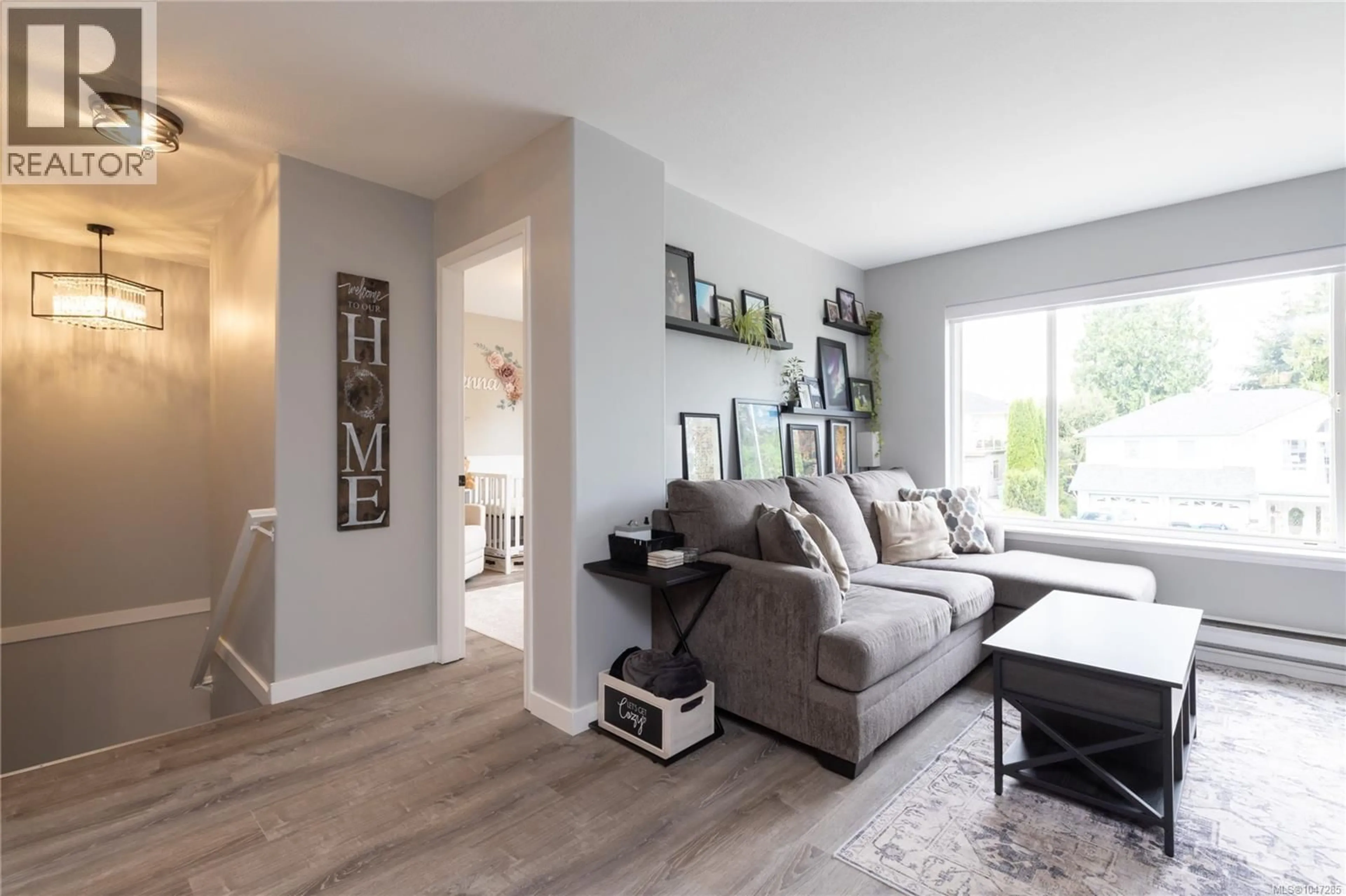 Living room with furniture, wood/laminate floor for 5824 CARRINGTON ROAD, Nanaimo British Columbia V9T6C2