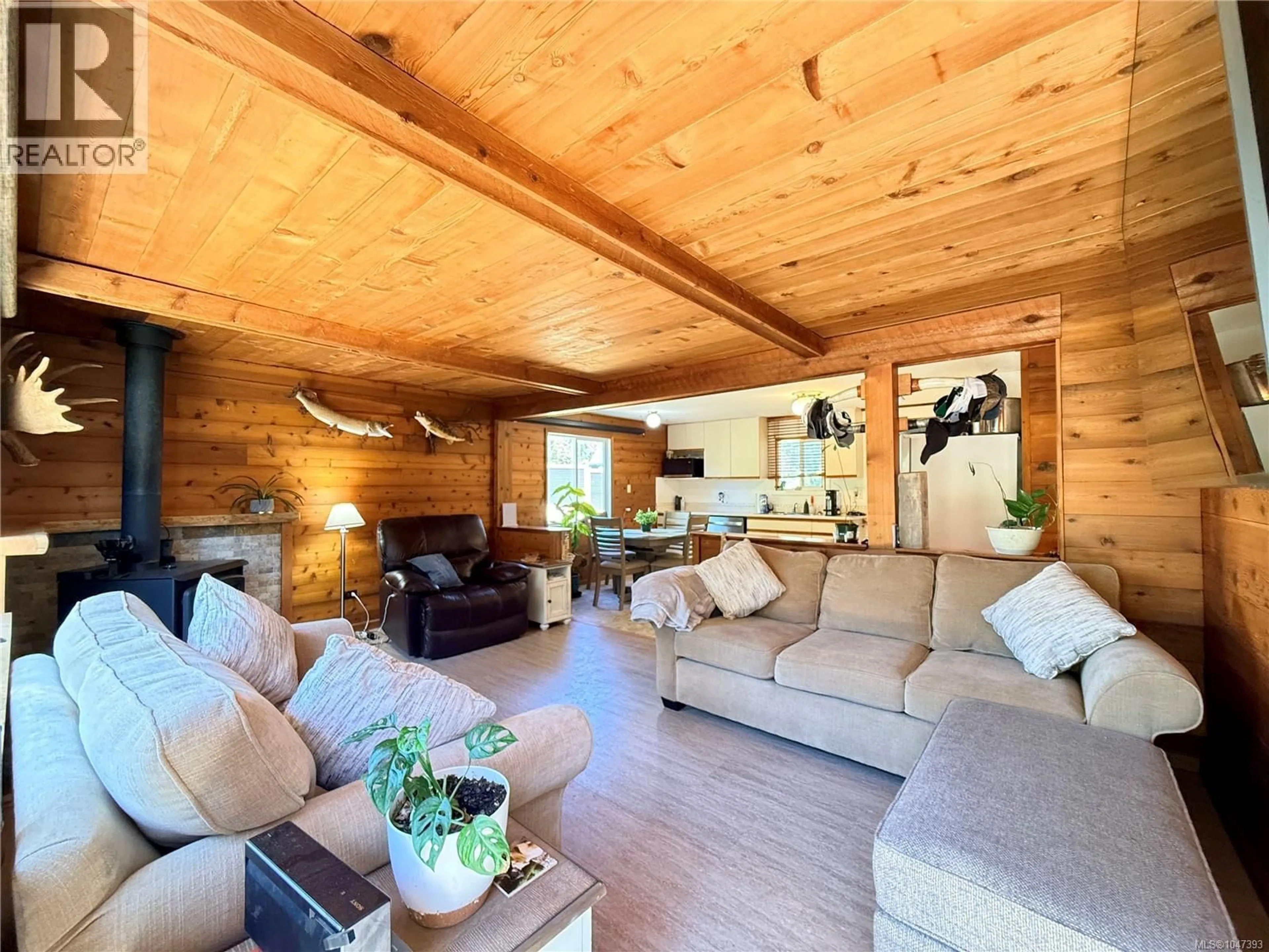 Living room with furniture, wood/laminate floor for 4069 NIMPKISH CRESCENT, Woss British Columbia V0N3P0