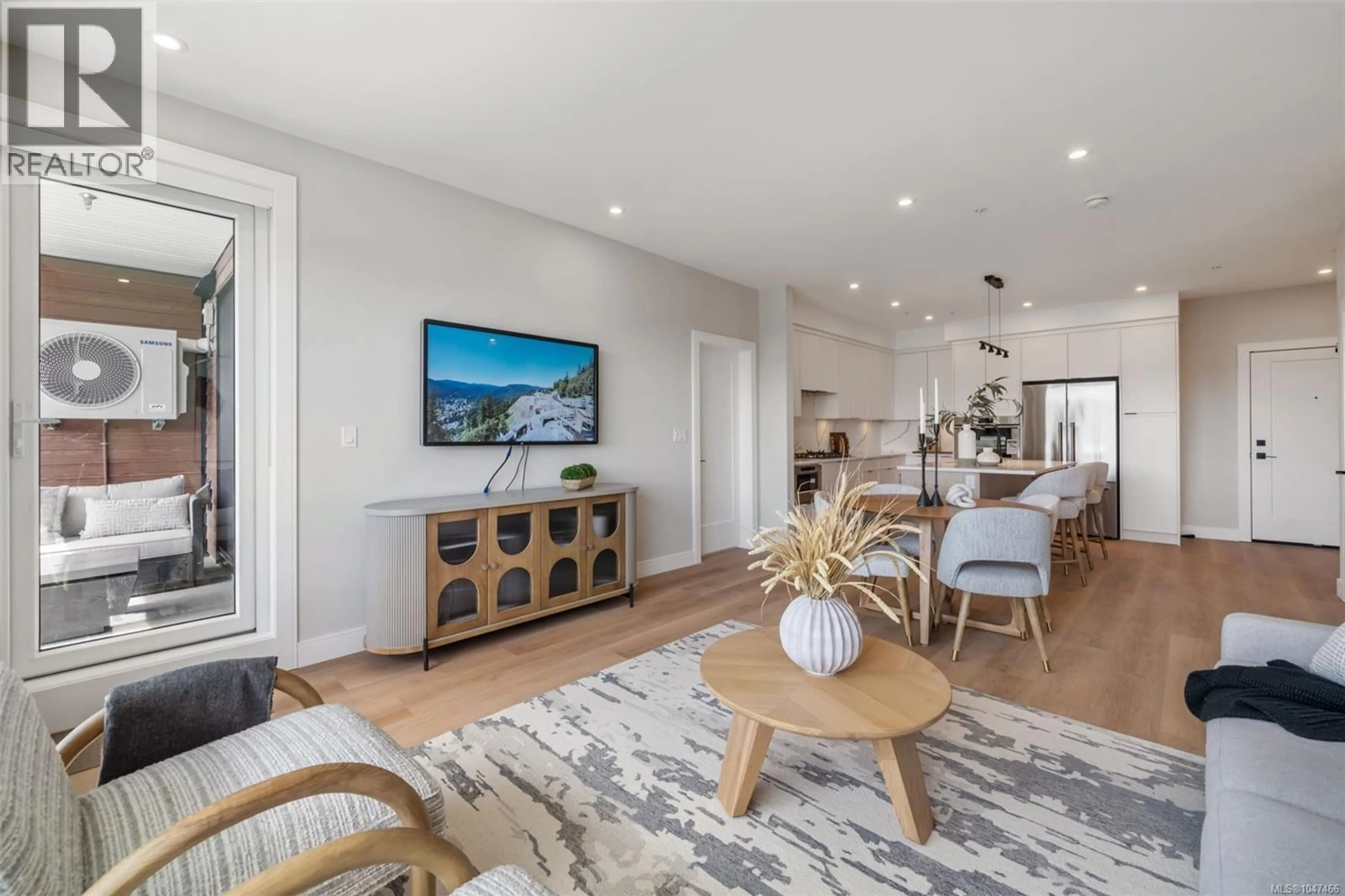 Living room with furniture, wood/laminate floor for 204 - 1810 SELENITE PLACE, Langford British Columbia V9B7E2