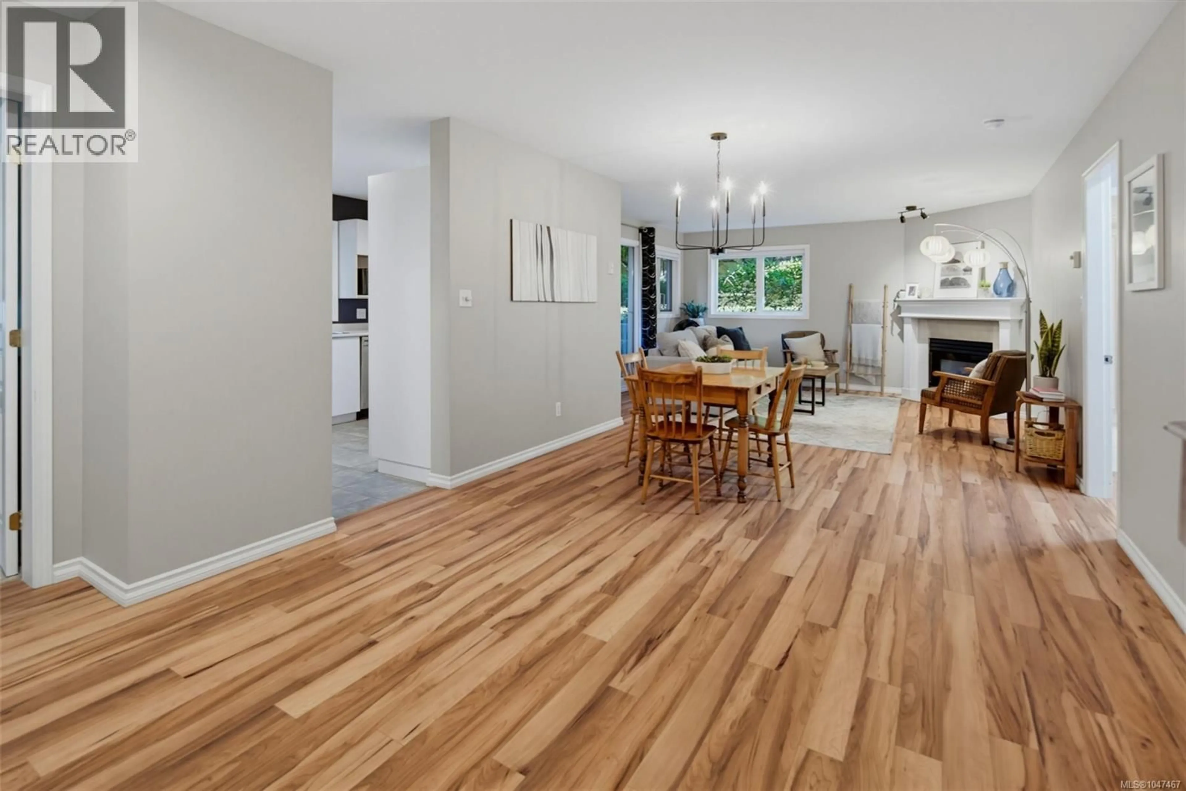 Open concept kitchen, wood/laminate floor for 103 - 494 MARSETT PLACE, Saanich British Columbia V8Z7J1