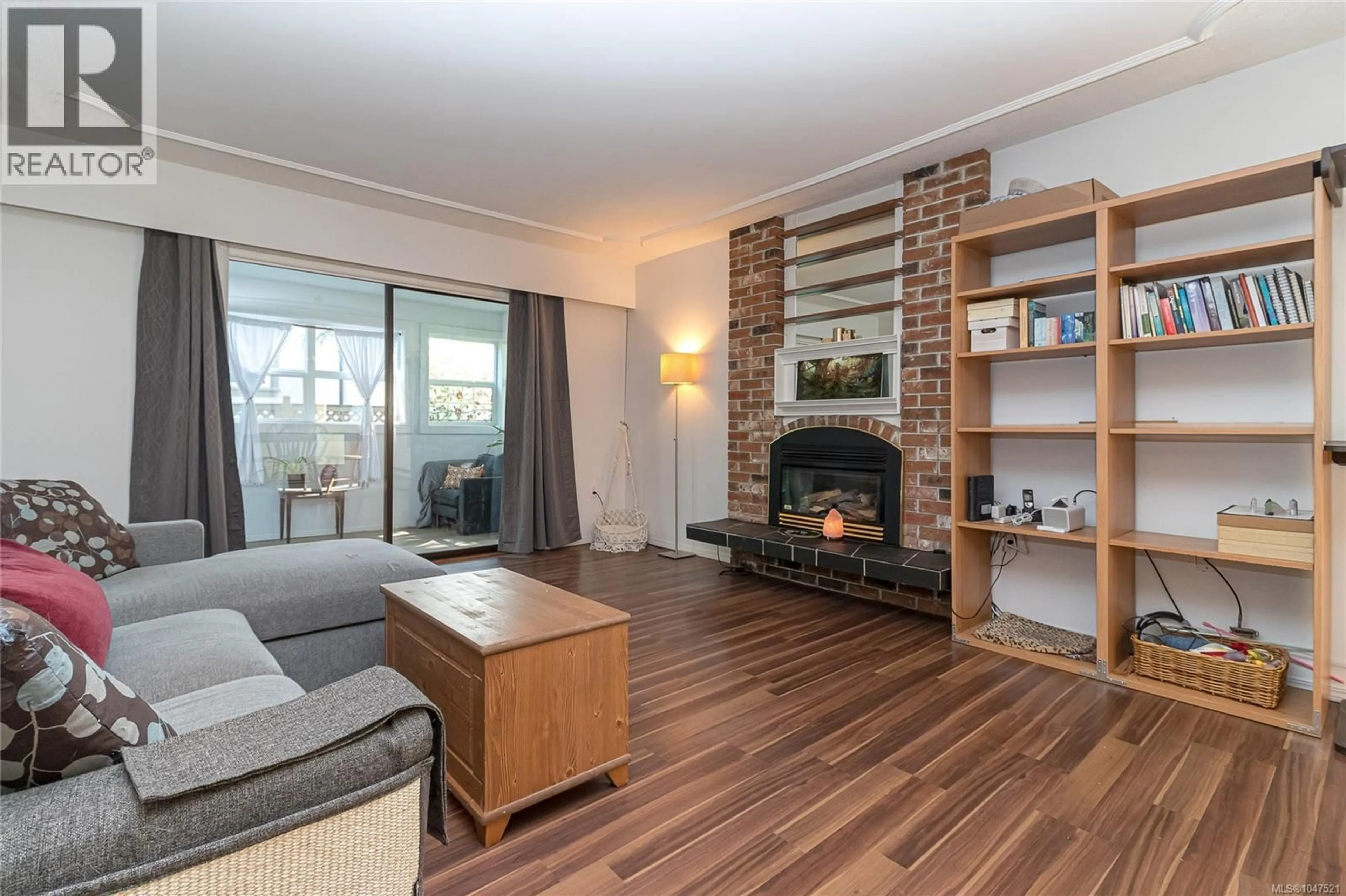 Living room with furniture, wood/laminate floor for 102 - 3244 SEATON STREET, Saanich British Columbia V8Z3V7