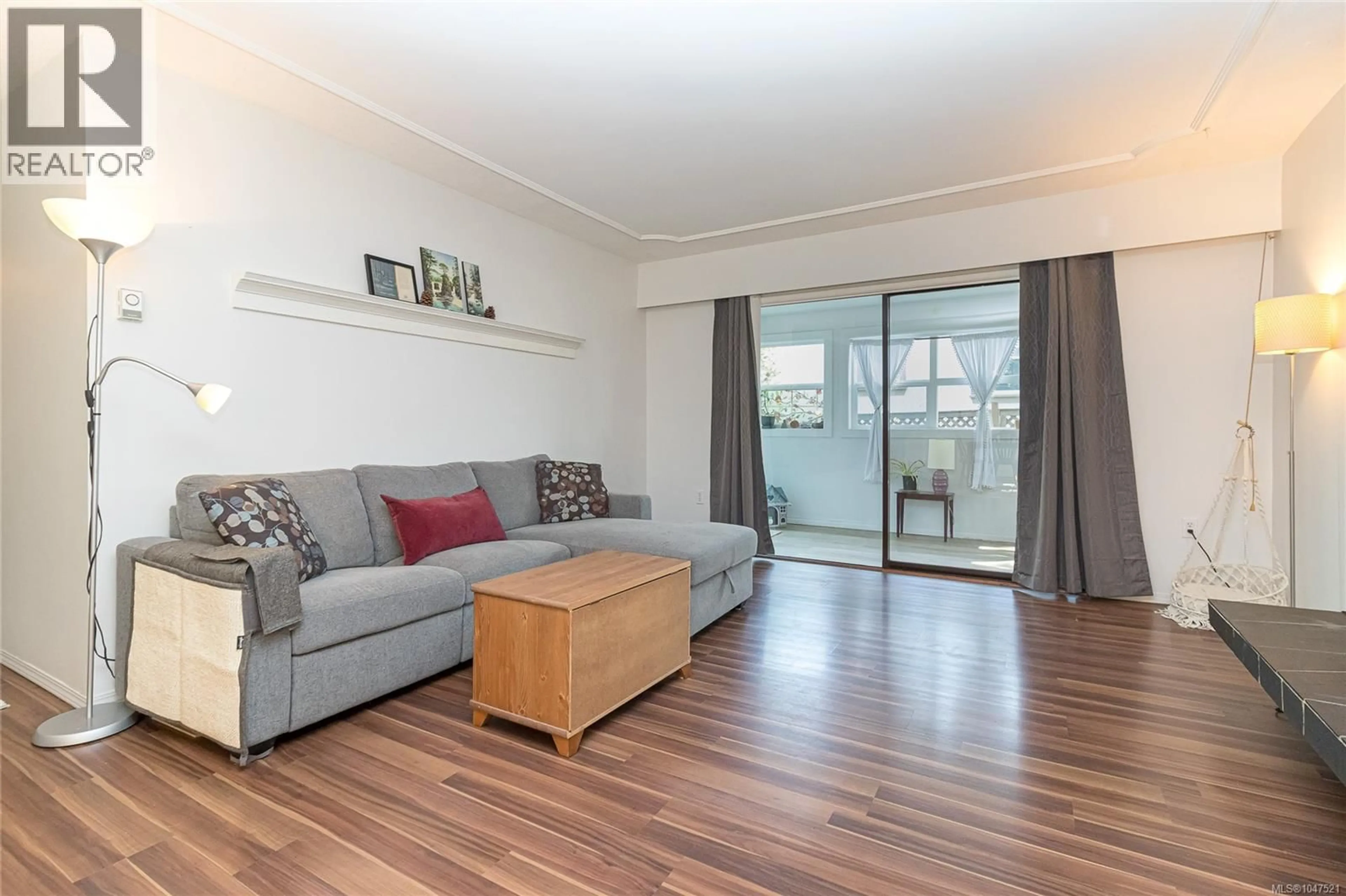 Living room with furniture, wood/laminate floor for 102 - 3244 SEATON STREET, Saanich British Columbia V8Z3V7