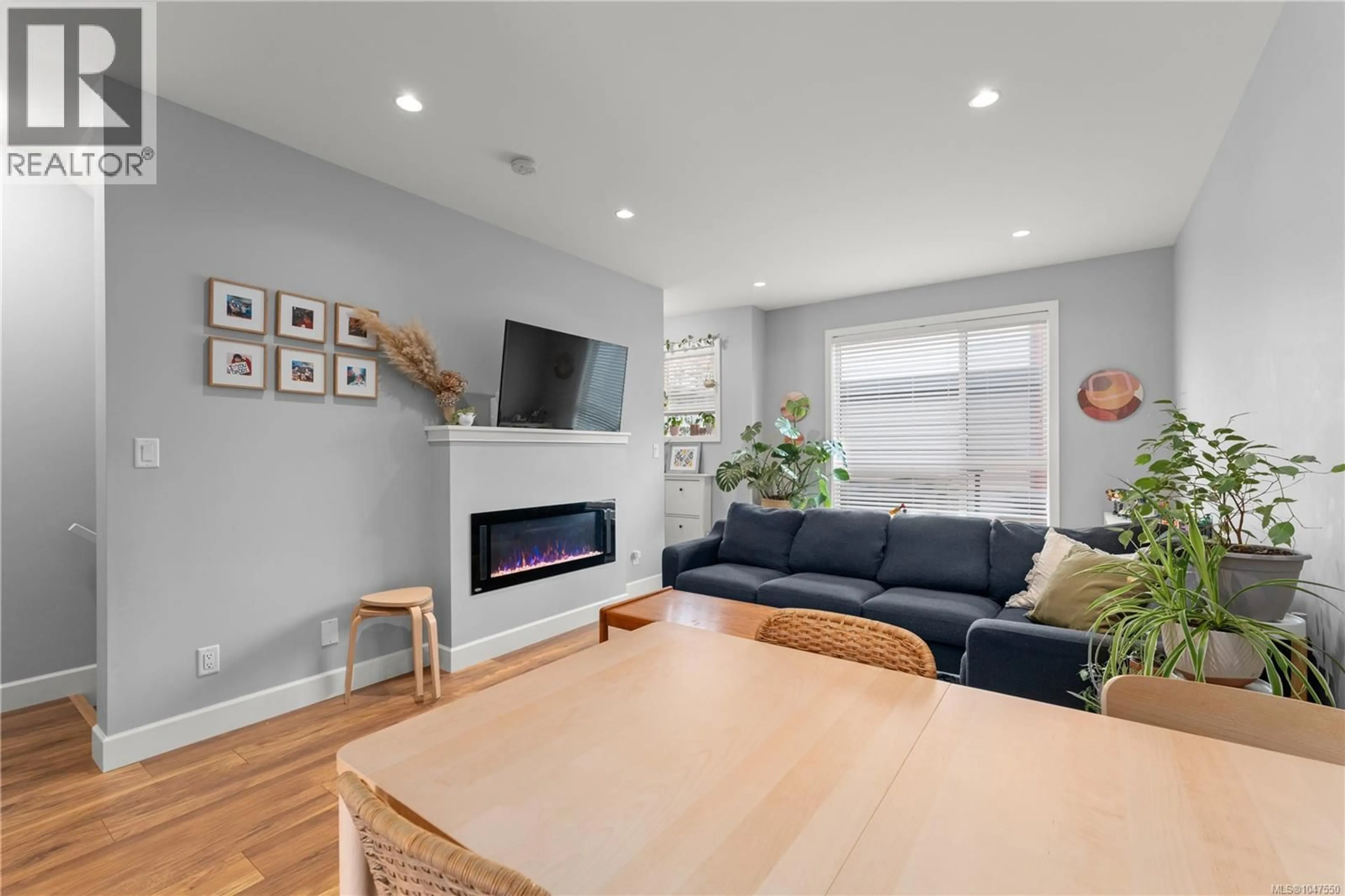 Living room with furniture, wood/laminate floor for 402 - 3351 LUXTON ROAD, Langford British Columbia V9C0P2