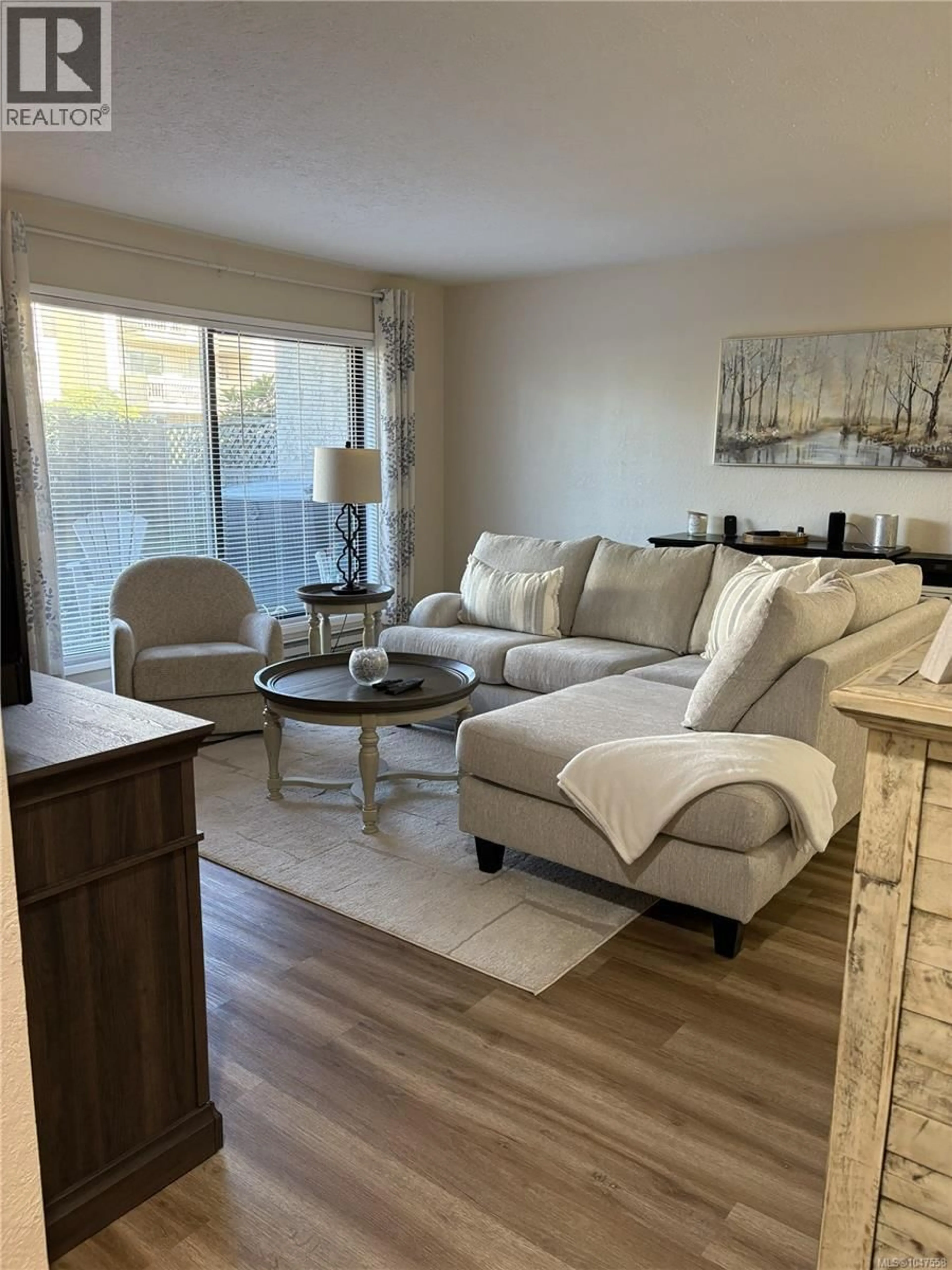 Living room with furniture, wood/laminate floor for 107 - 363 MORISON AVENUE, Parksville British Columbia V9P1P4