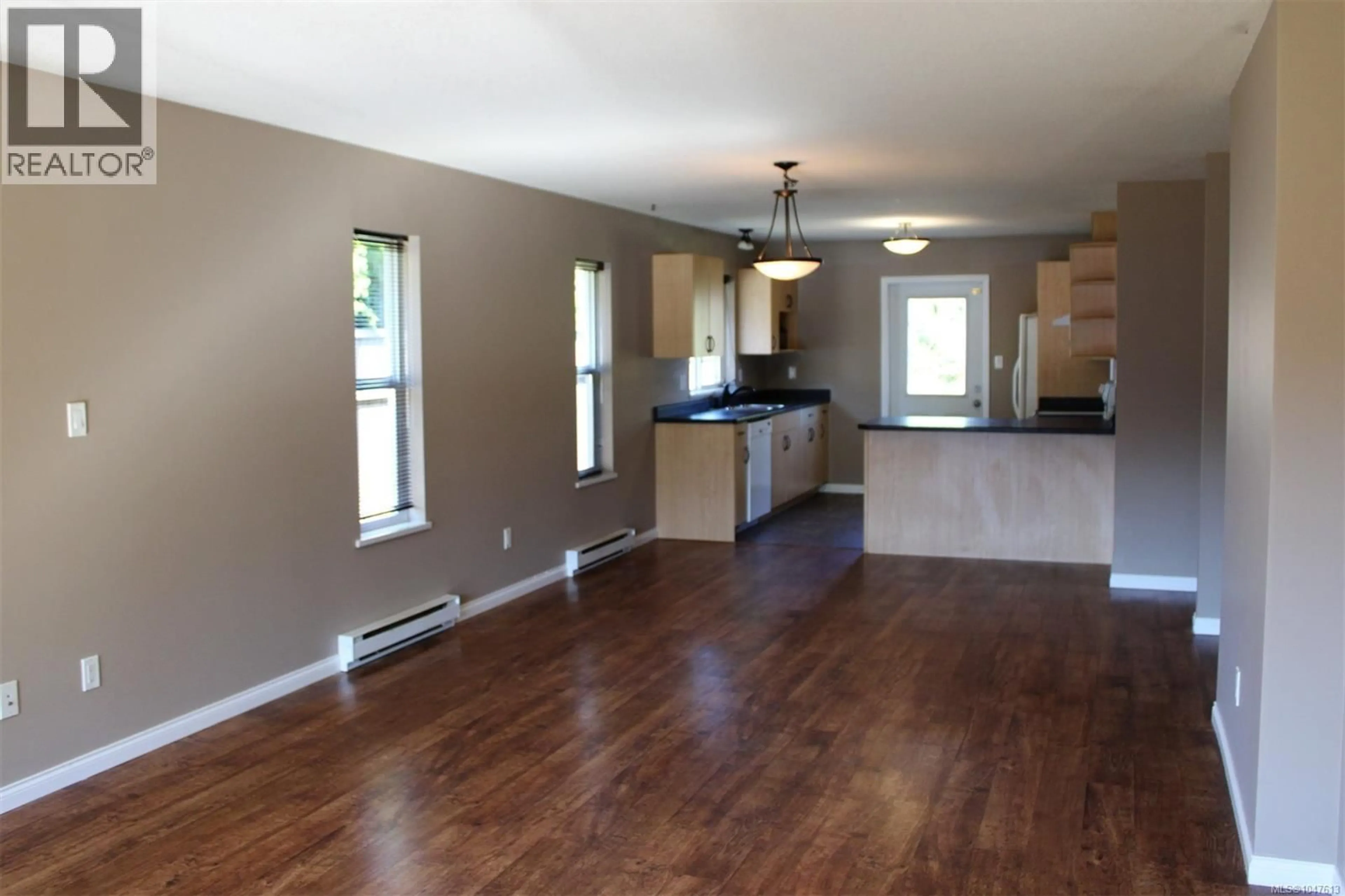 Open concept kitchen, wood/laminate floor for 3381 CONISTON CRESCENT, Cumberland British Columbia V0R1S0
