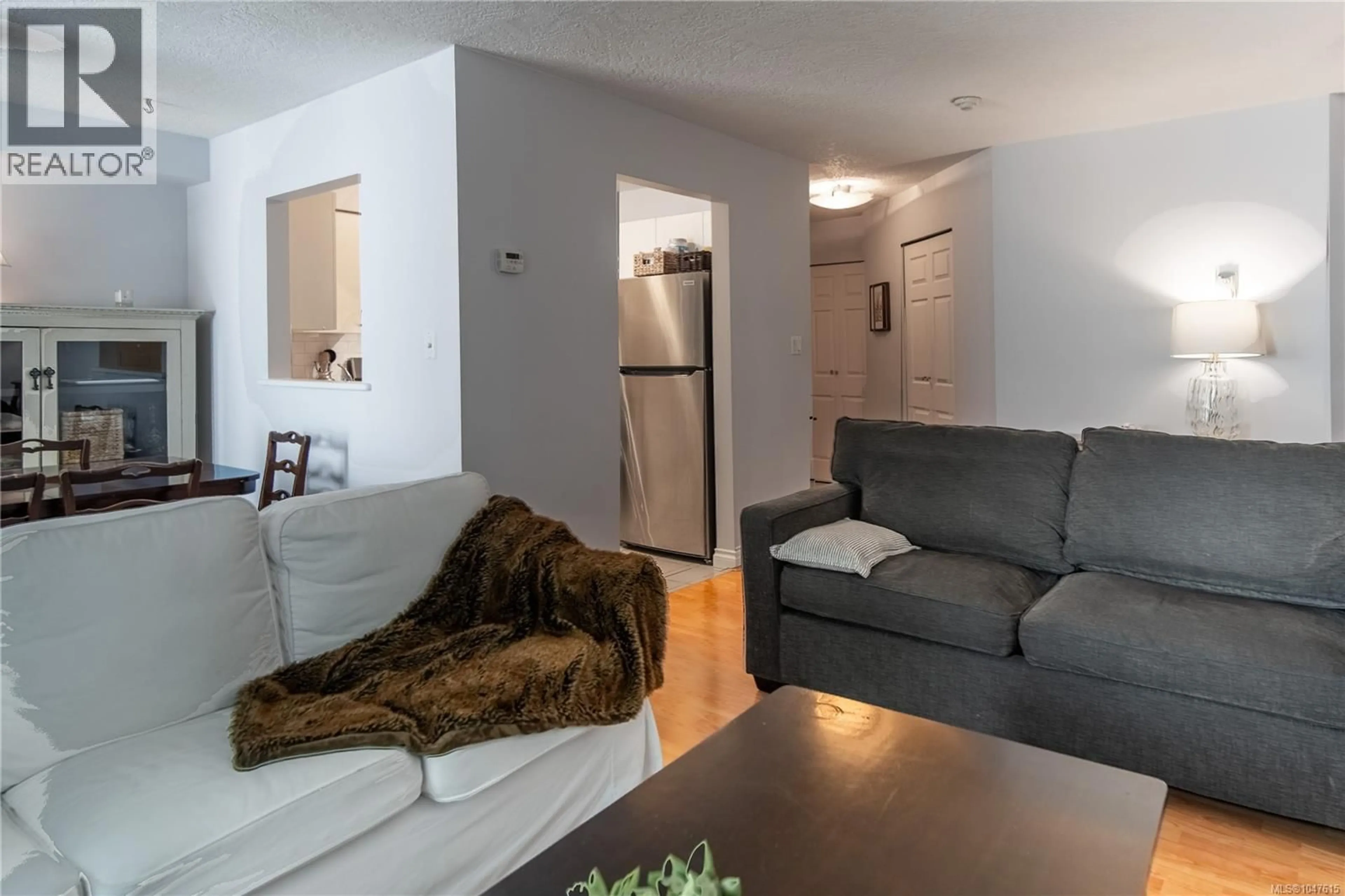 Living room with furniture, wood/laminate floor for 304 - 832 FISGARD STREET, Victoria British Columbia V8W1S1