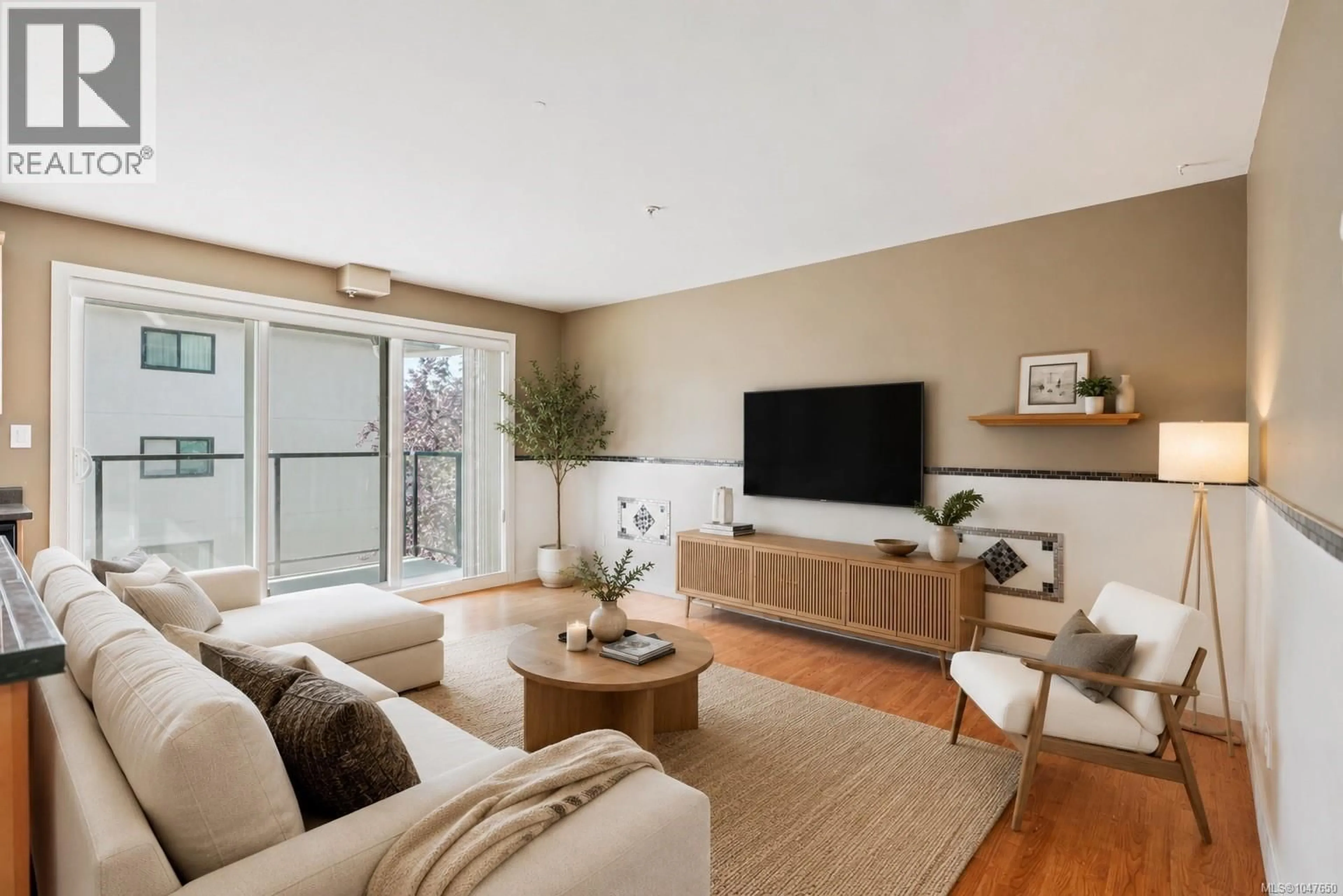 Living room with furniture, wood/laminate floor for 304 - 2940 HARRIET ROAD, Saanich British Columbia V8N1A1