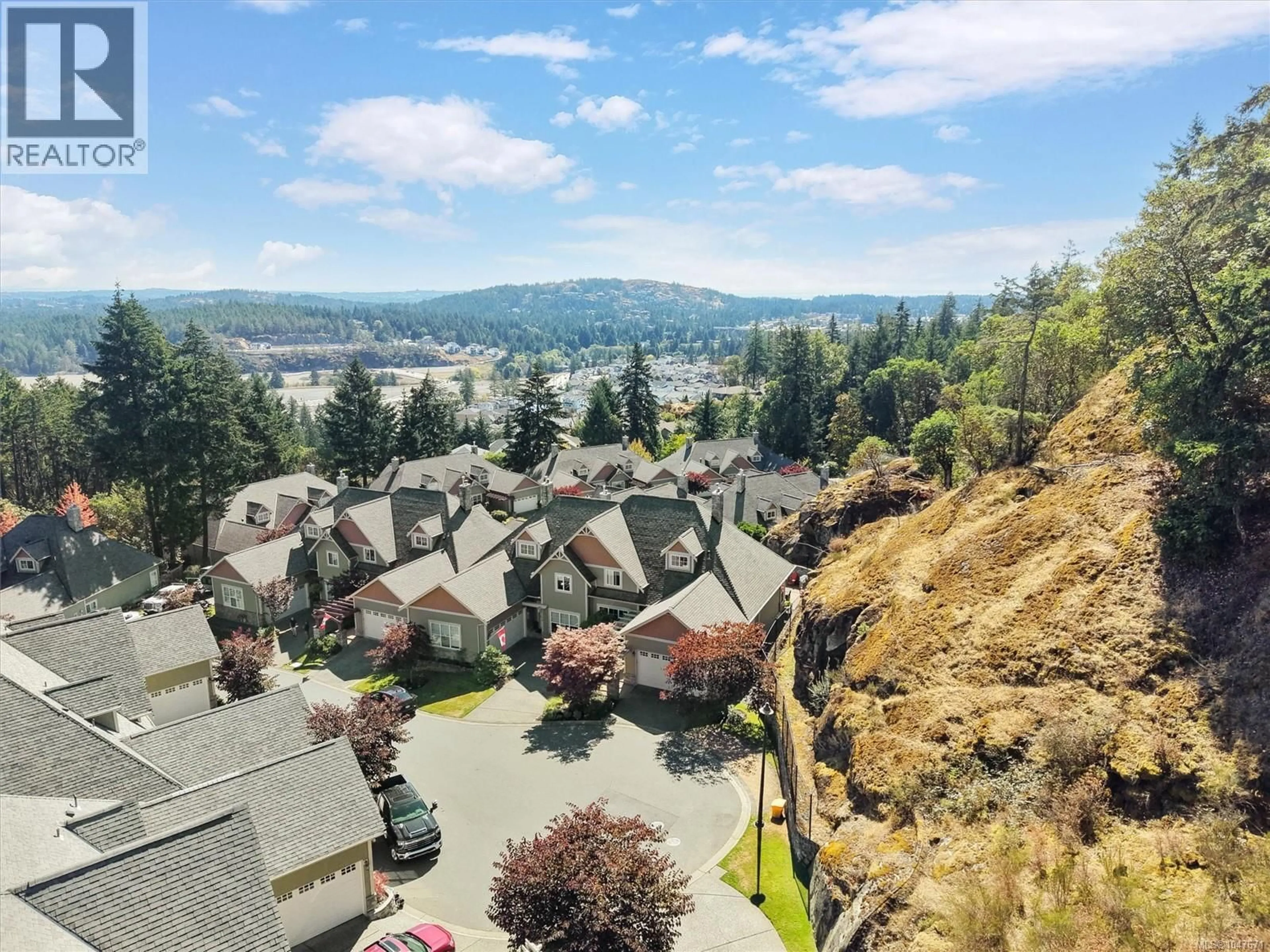 A pic from outside/outdoor area/front of a property/back of a property/a pic from drone, mountain view for 102 - 945 BEAR MOUNTAIN PARKWAY, Langford British Columbia V9B6T1