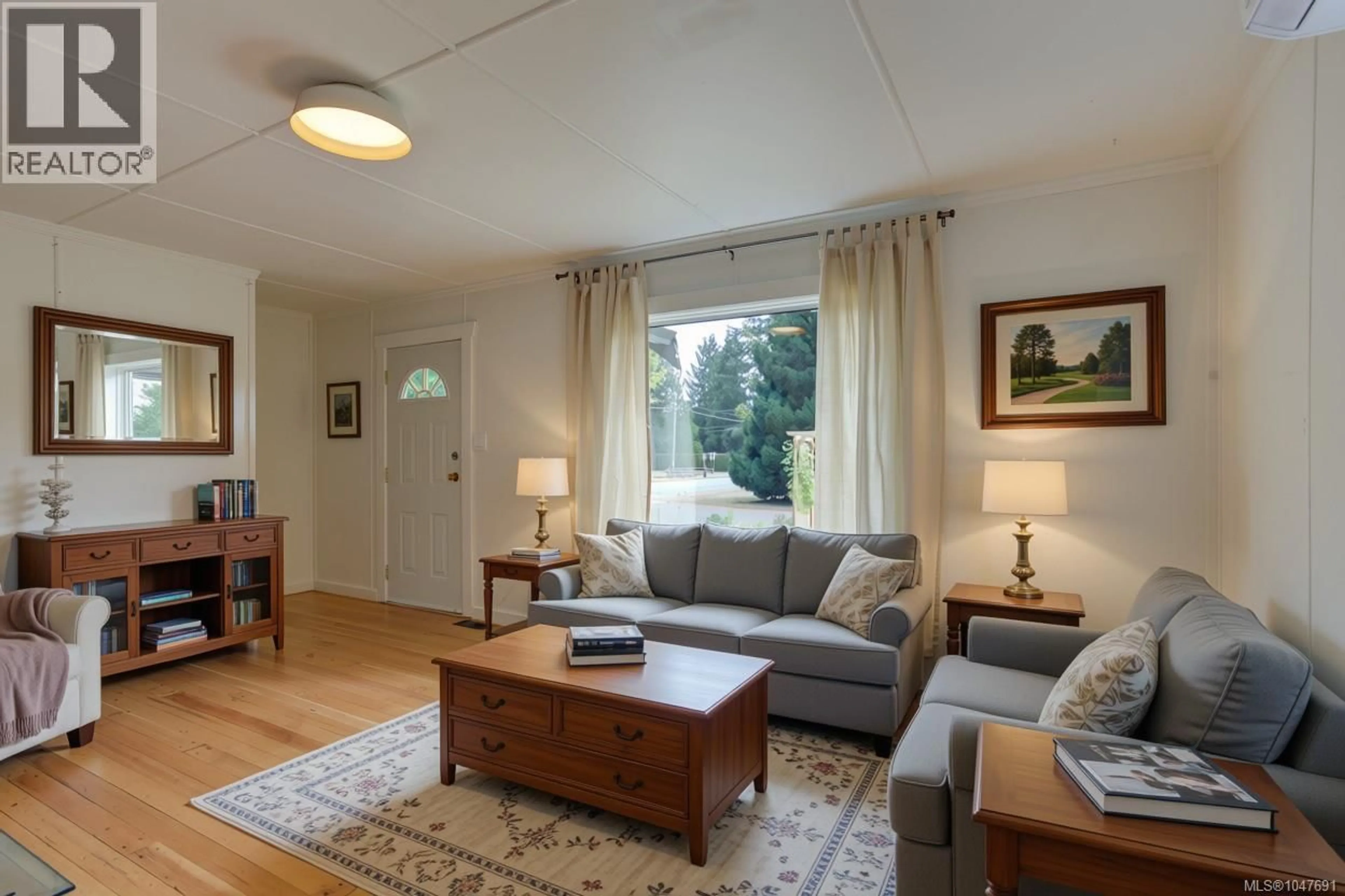 Living room with furniture, wood/laminate floor for 6810 THIRD STREET, Honeymoon Bay British Columbia V0R1Y0