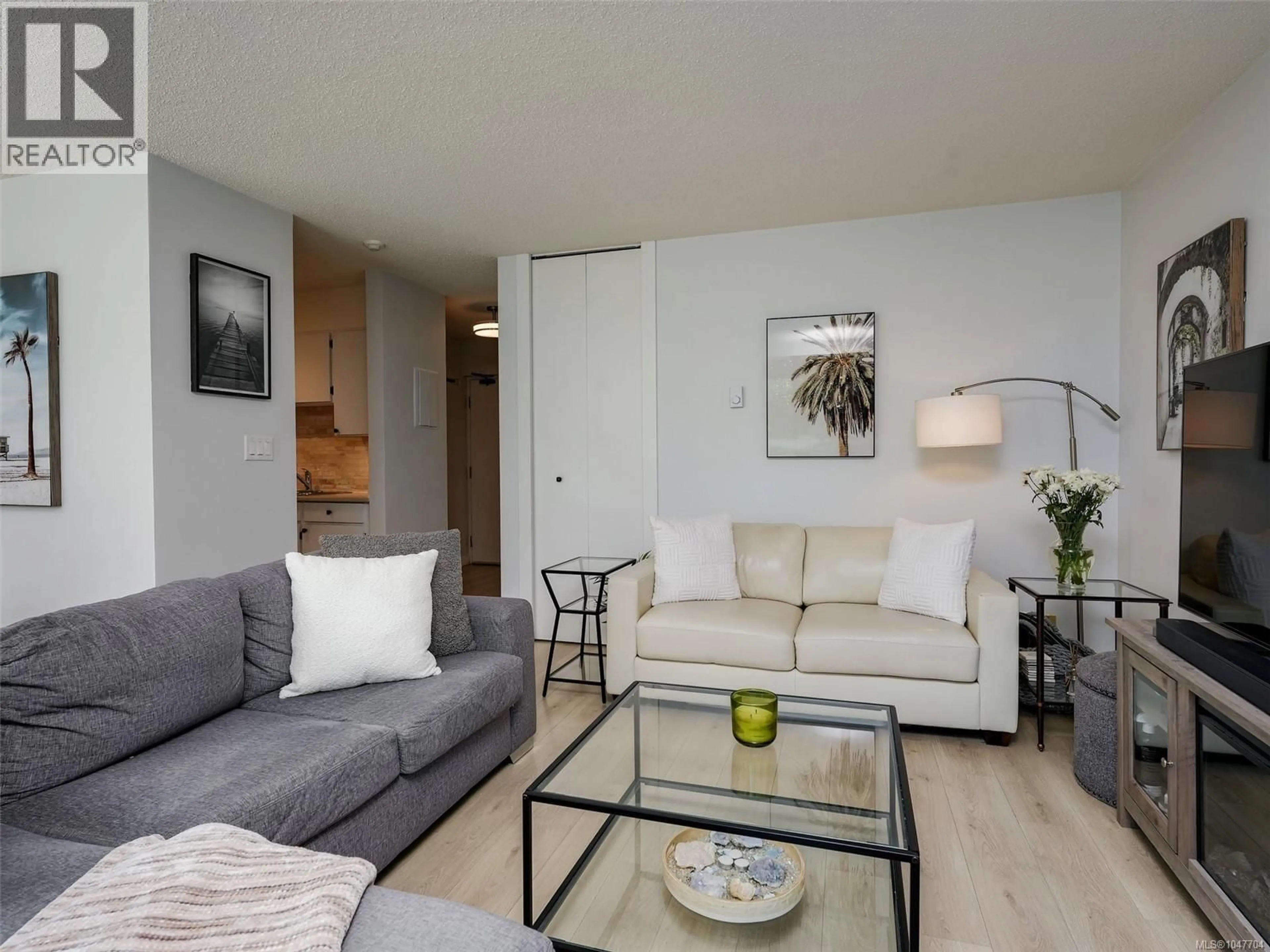 Living room with furniture, wood/laminate floor for 103 - 327 MAITLAND STREET, Victoria British Columbia V9A7G7