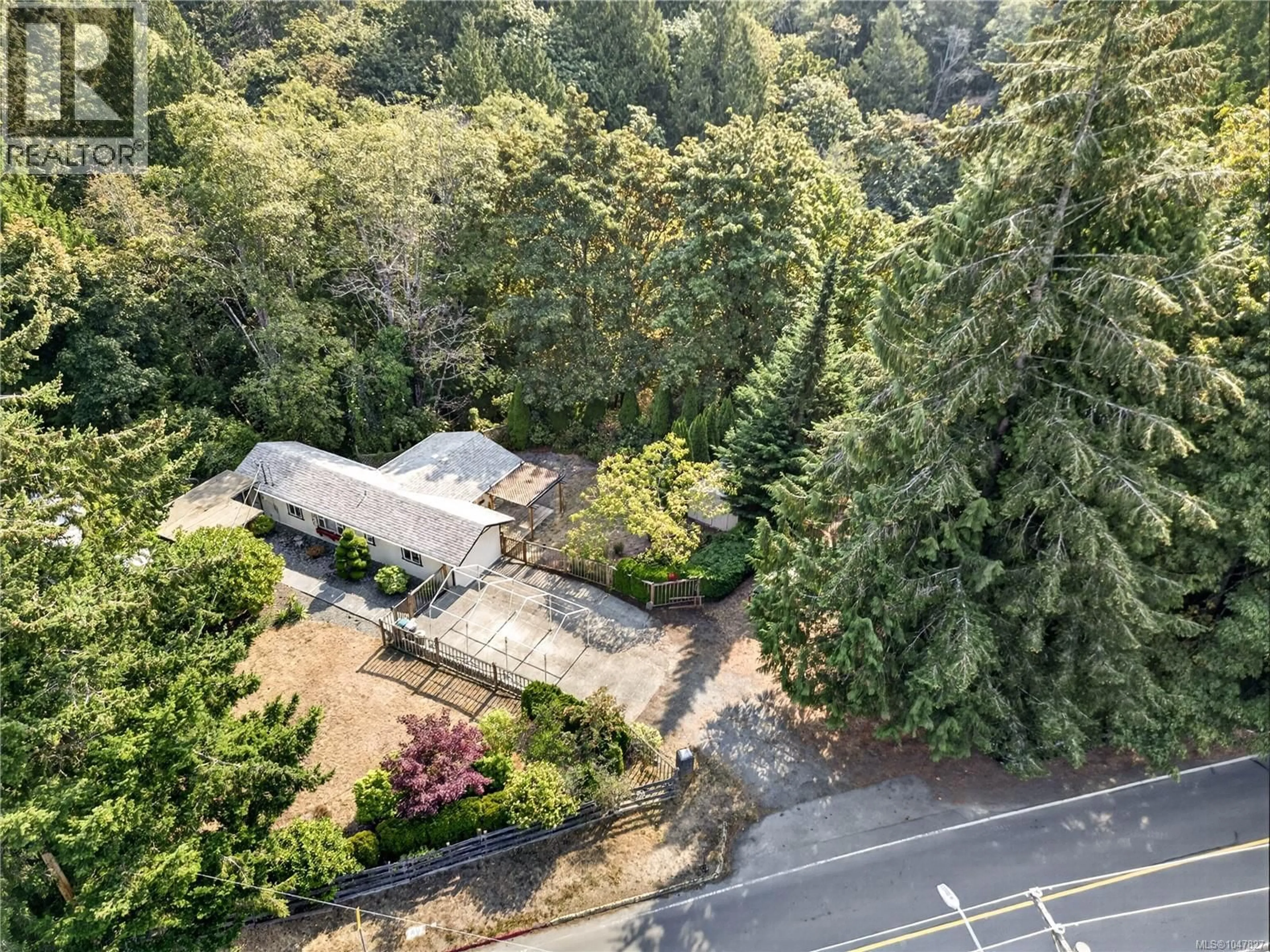 A pic from outside/outdoor area/front of a property/back of a property/a pic from drone, forest/trees view for 205 ATKINS ROAD, View Royal British Columbia V9B2Z8