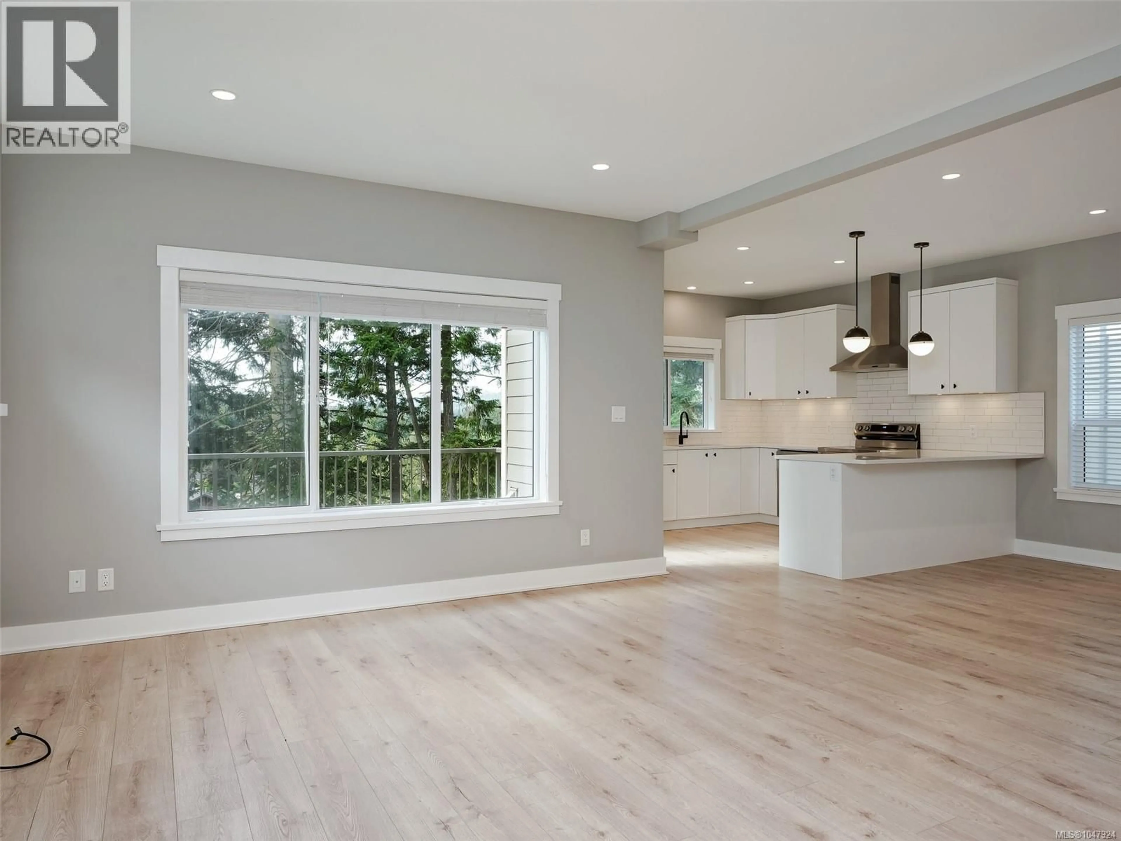 Open concept kitchen, wood/laminate floor for 3632 HONEYCRISP AVENUE, Langford British Columbia V9C0N5