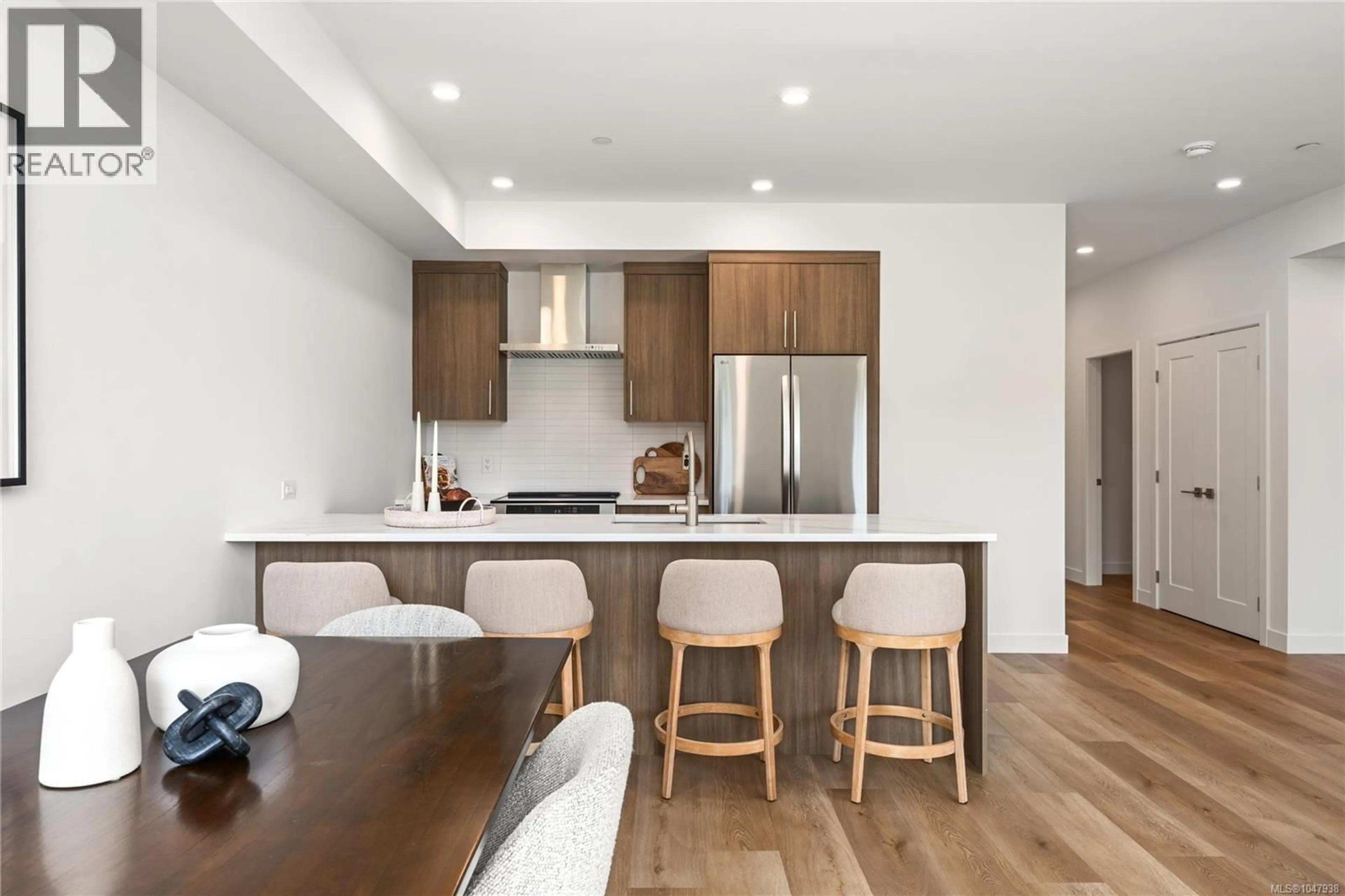 Open concept kitchen, wood/laminate floor for 203 - 7181 LANTZVILLE ROAD, Lantzville British Columbia V0R2H0