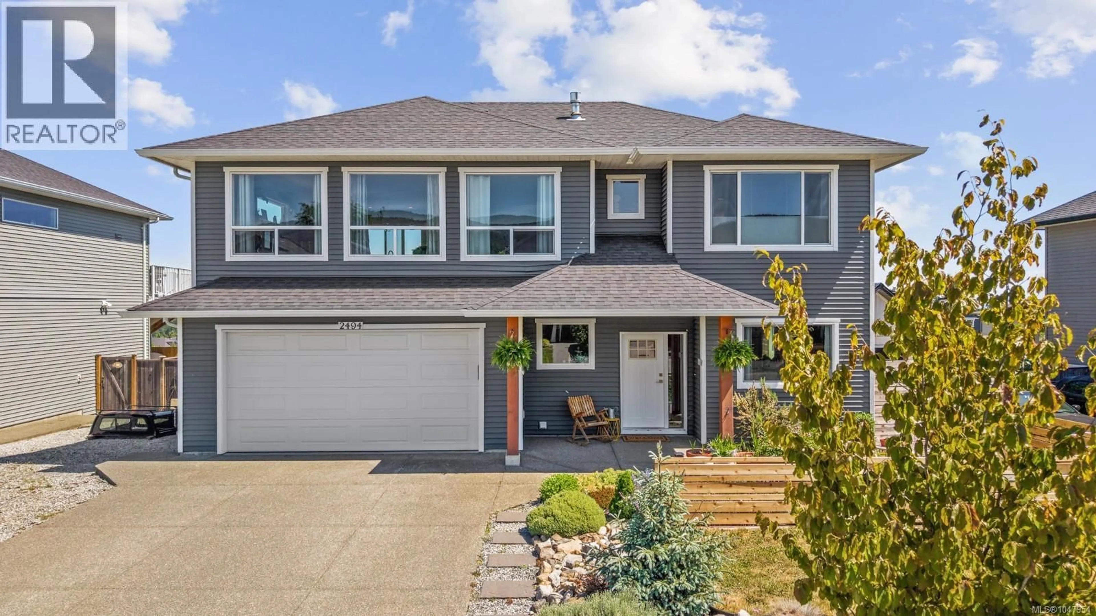 Home with vinyl exterior material, street for 2494 KENTMERE AVENUE, Cumberland British Columbia V0R1S0