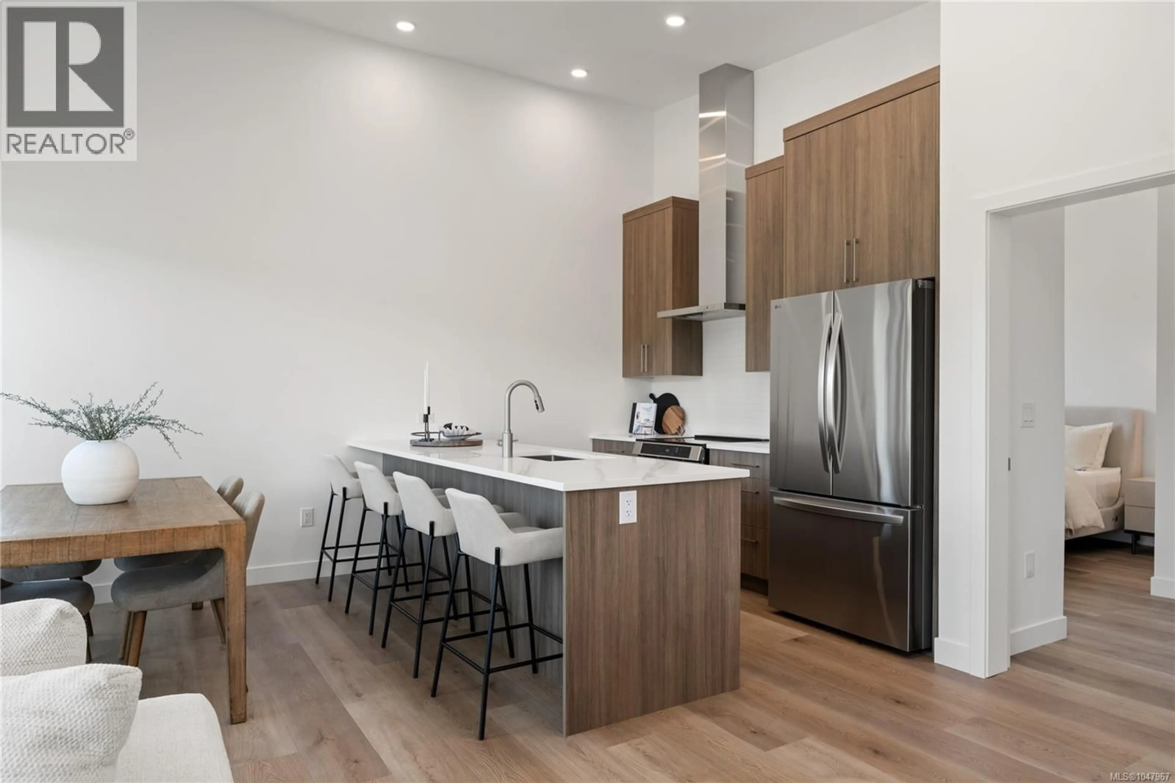 Open concept kitchen, wood/laminate floor for 306 - 7181 LANTZVILLE ROAD, Lantzville British Columbia V0R2H0