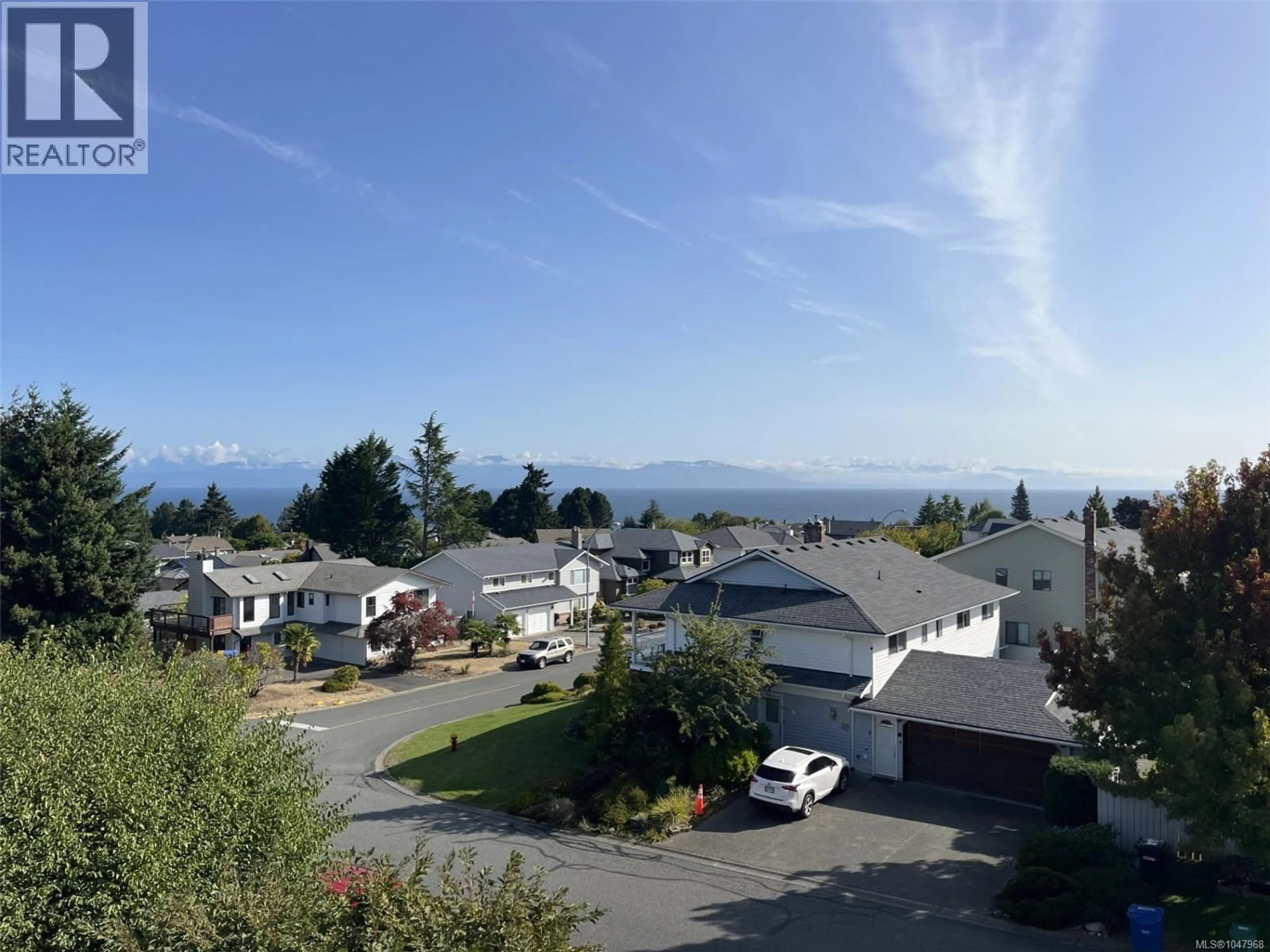 A pic from outside/outdoor area/front of a property/back of a property/a pic from drone, mountain view for 212A - 6231 BLUEBACK ROAD, Nanaimo British Columbia V9V1J3