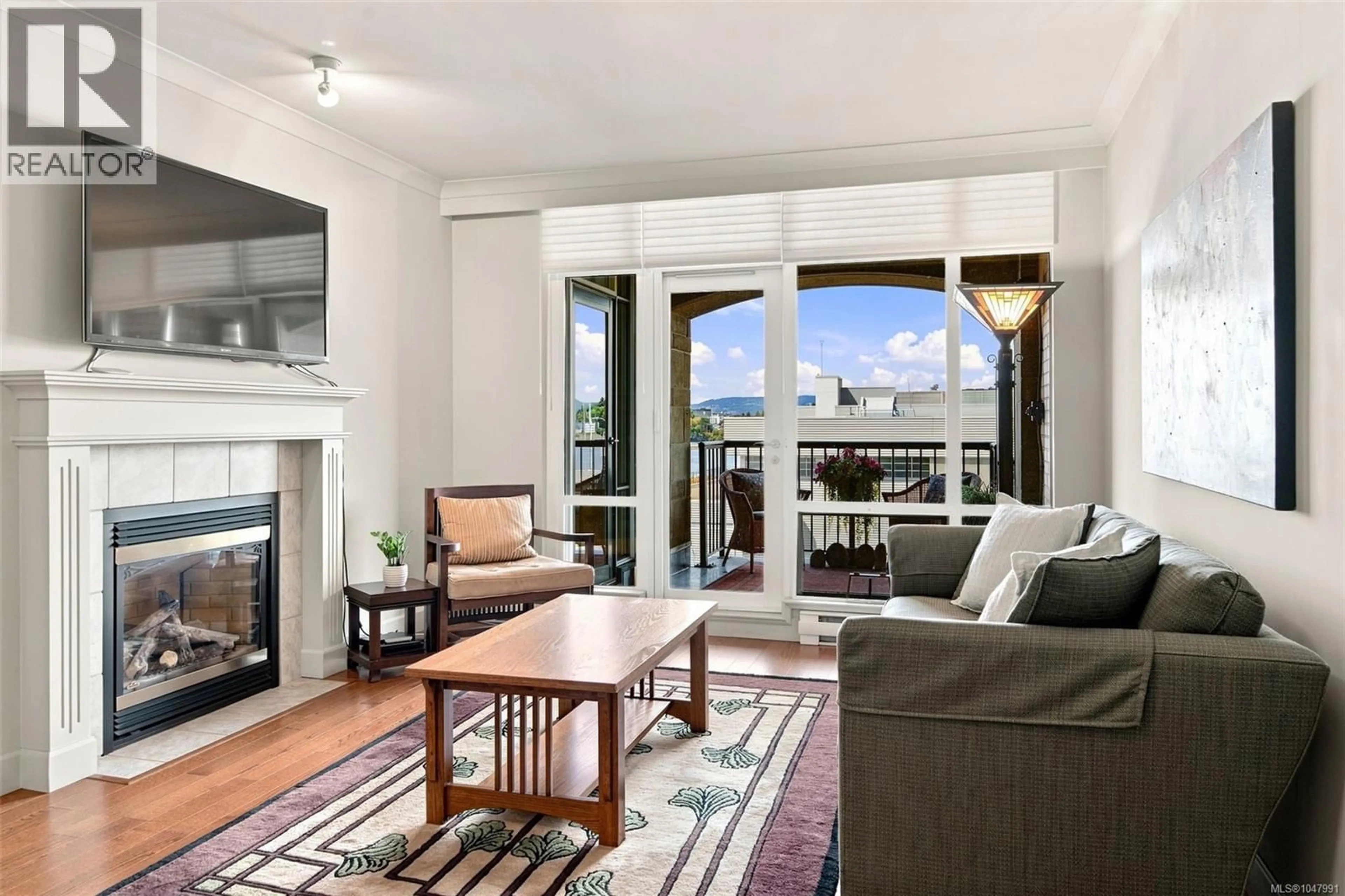 Living room with furniture, wood/laminate floor for 414 - 21 DALLAS ROAD, Victoria British Columbia V8V4Z9