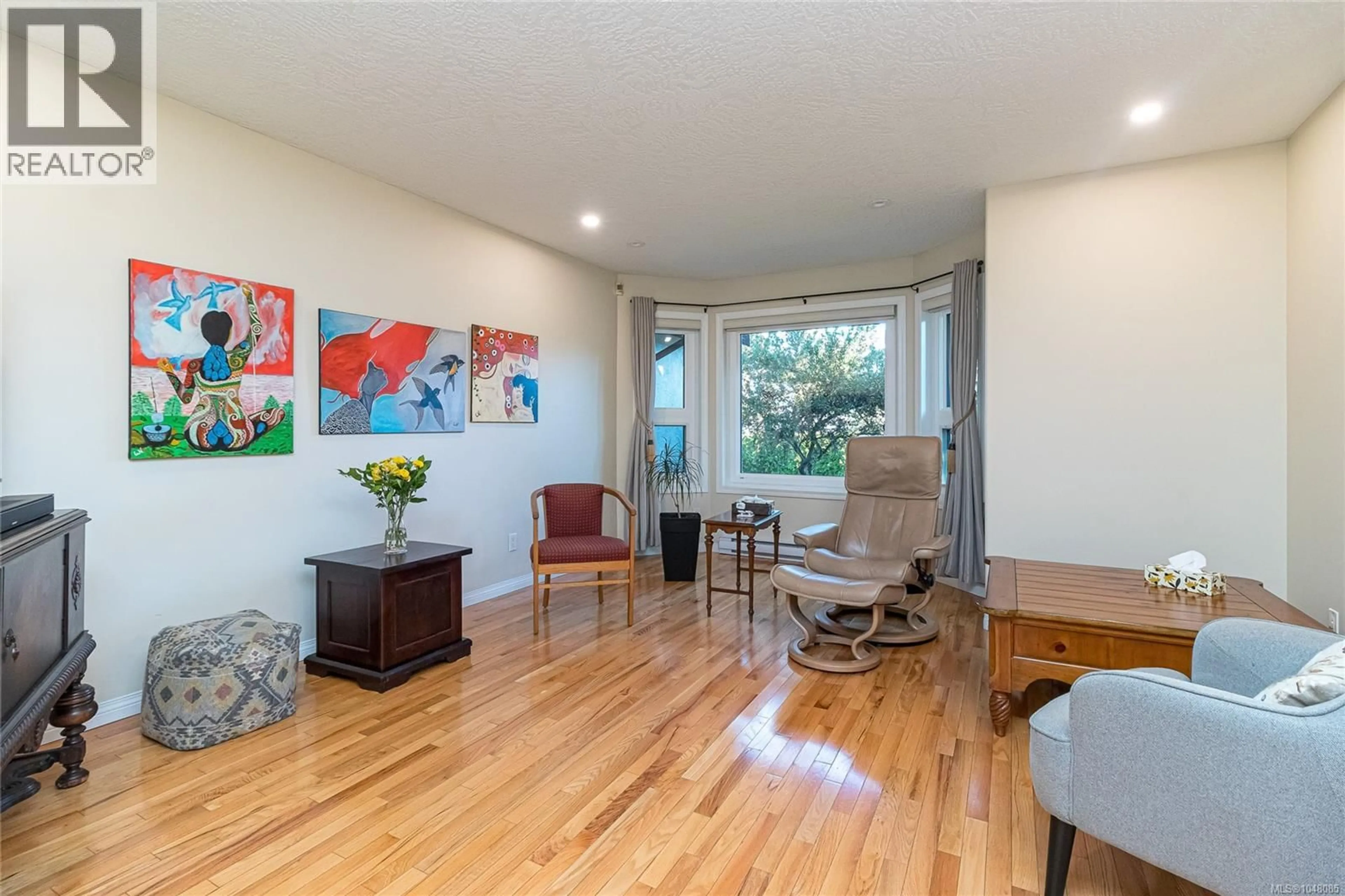 Living room with furniture, wood/laminate floor for 3910 CEDAR HILL CROSS ROAD, Saanich British Columbia V8P2N2