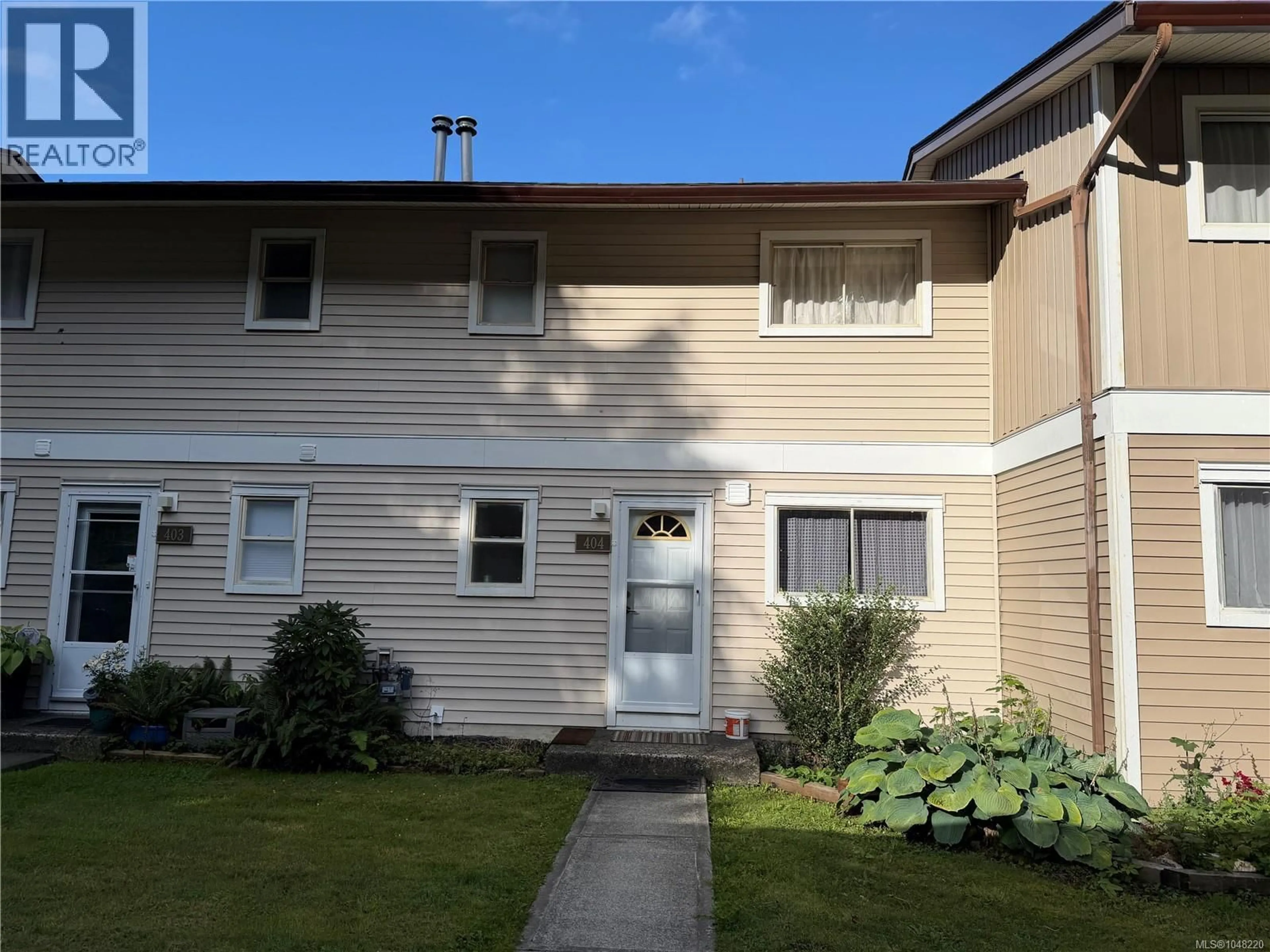 Home with vinyl exterior material, street for 404 HAIDA AVENUE, Port Alice British Columbia V0N2N0