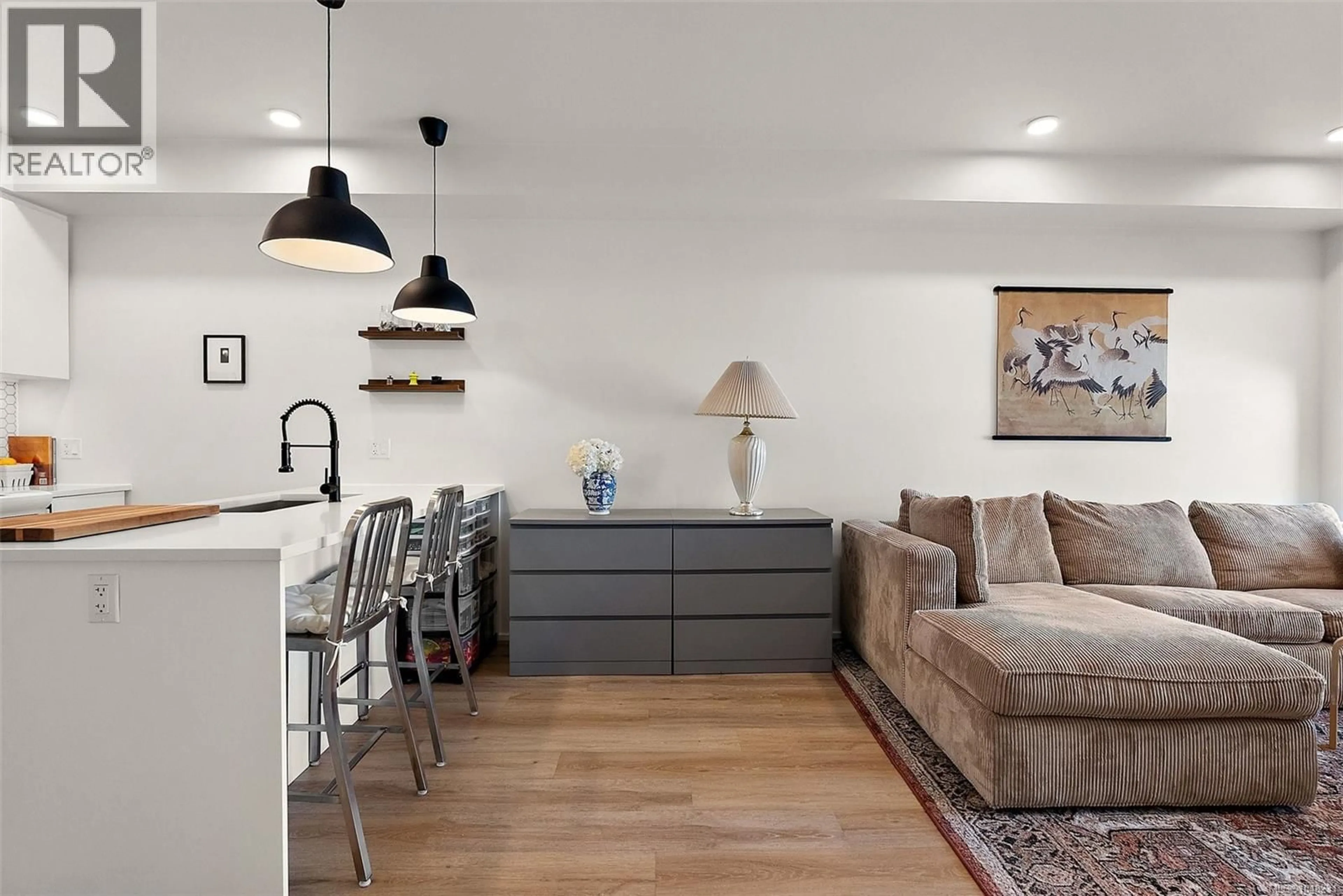 Living room with furniture, wood/laminate floor for 203 - 2348 BEACON AVENUE, Sidney British Columbia V8L1X3