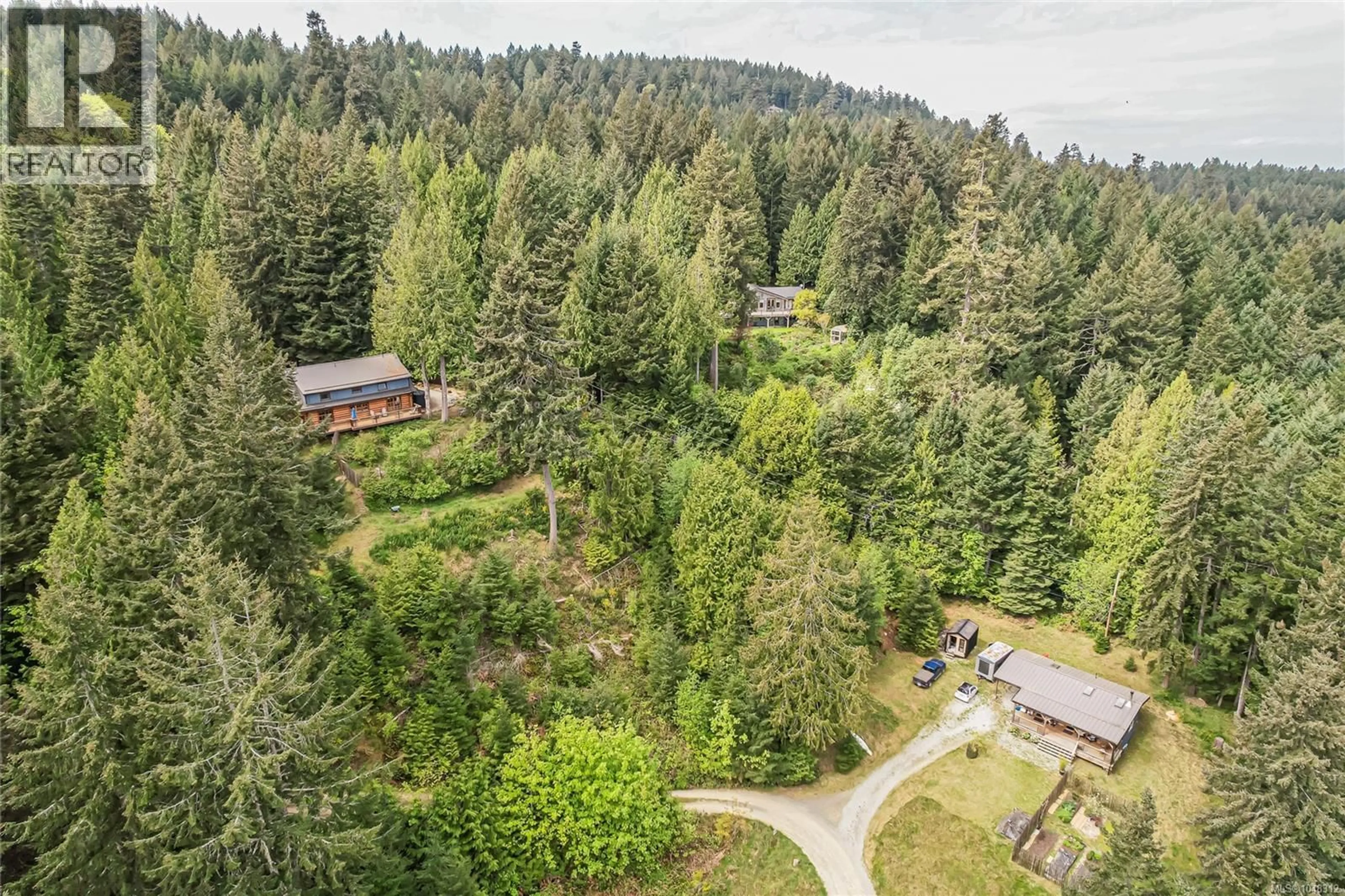 A pic from outside/outdoor area/front of a property/back of a property/a pic from drone, forest/trees view for 129 MARIKO PLACE, Salt Spring British Columbia V8K1E1