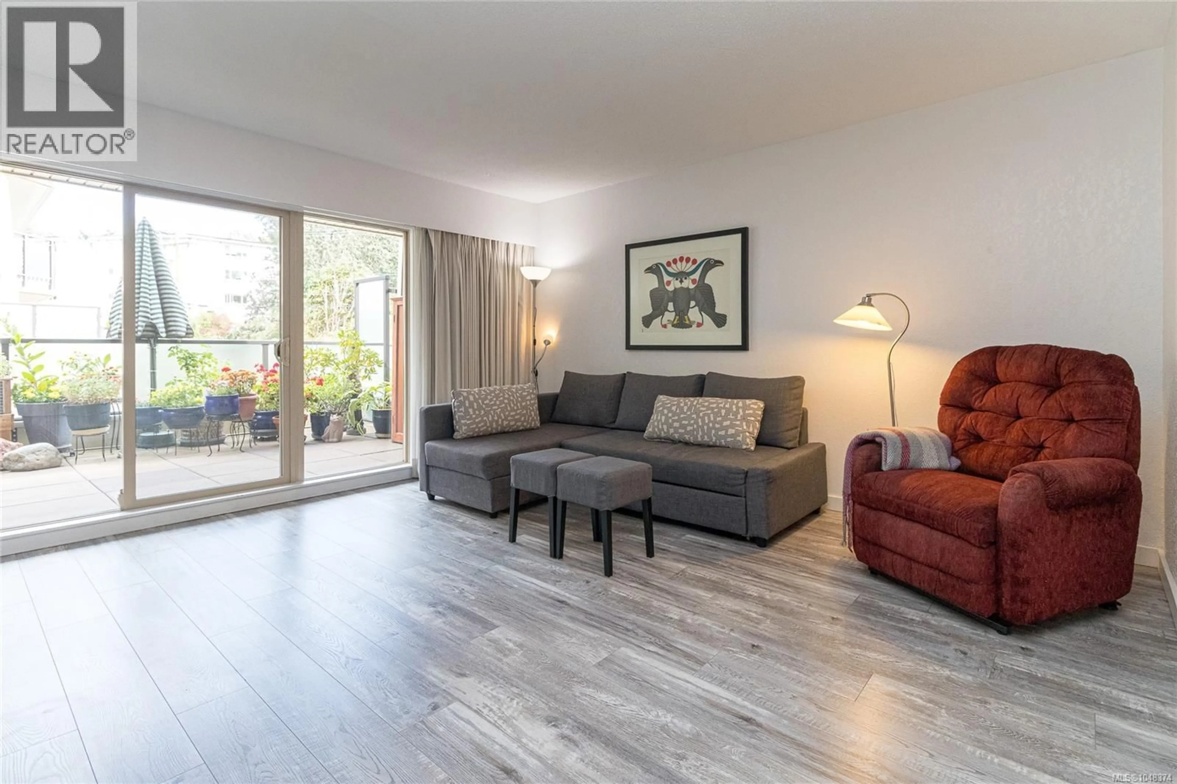 Living room with furniture, wood/laminate floor for 212 - 1545 PANDORA AVENUE, Victoria British Columbia V8R6R1