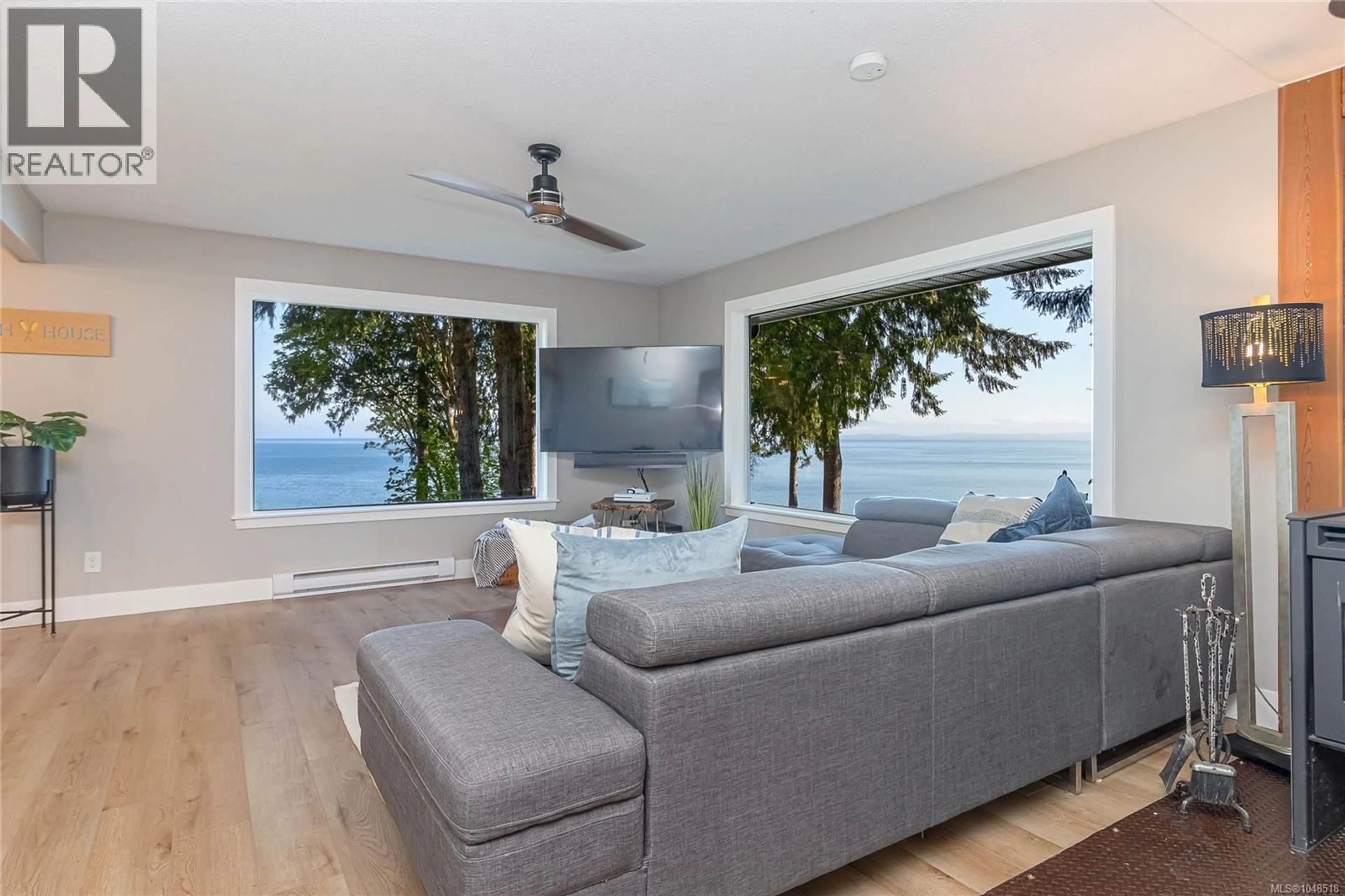 Living room with furniture, wood/laminate floor for 2519 LASQUETI ROAD, Qualicum Beach British Columbia V9K1Z1