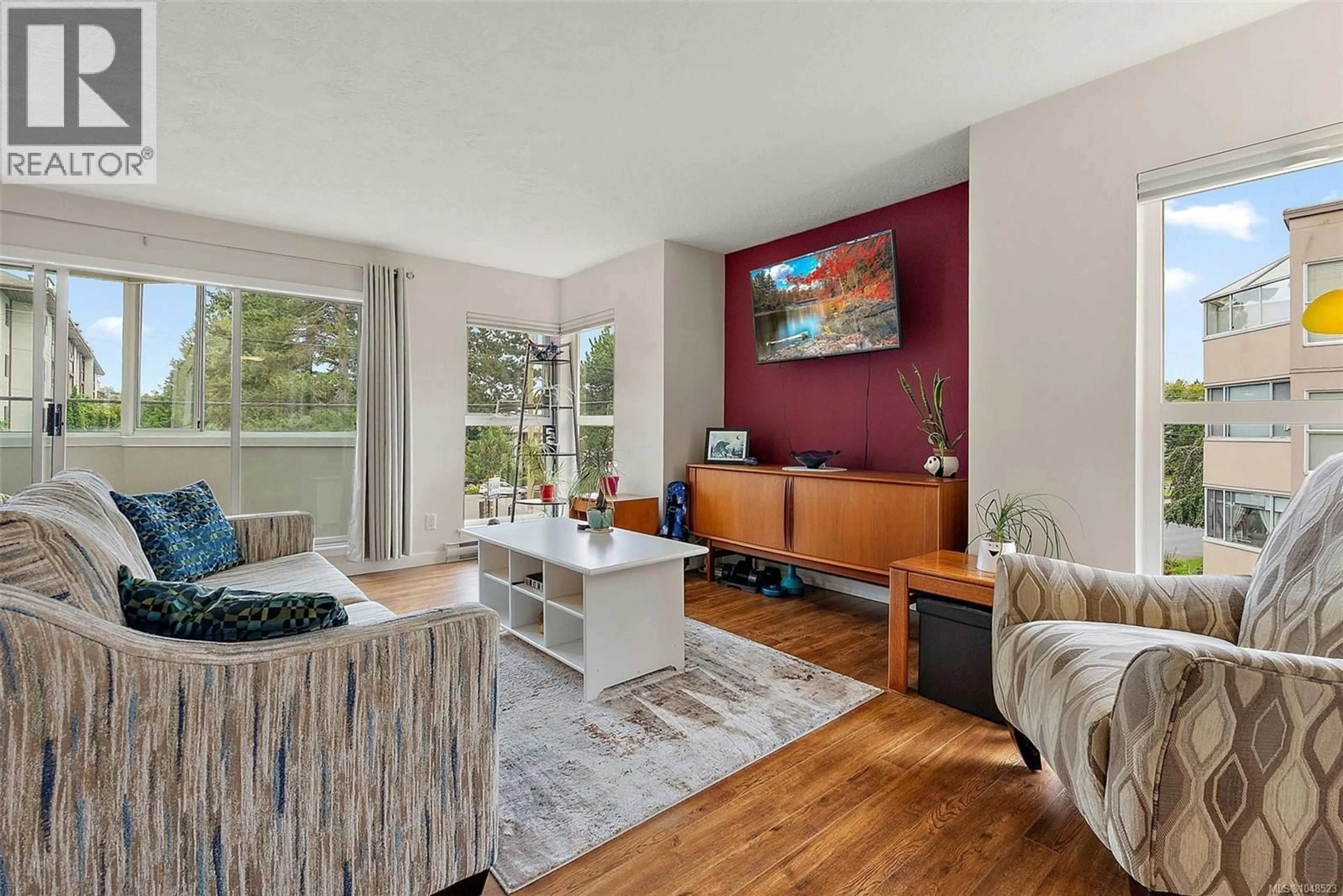 Living room with furniture, wood/laminate floor for 219 - 40 GORGE ROAD WEST, Saanich British Columbia V9A1L8