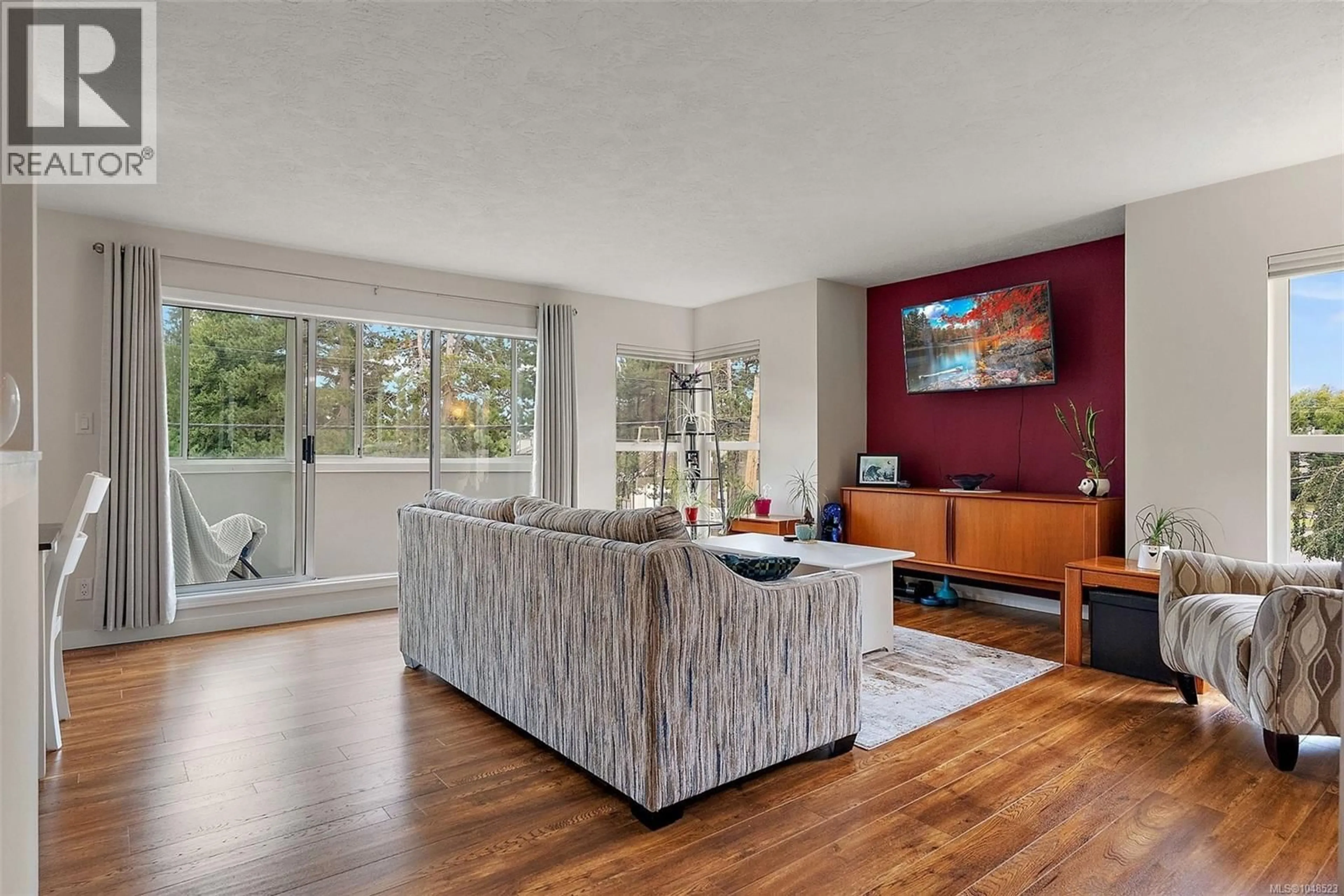 Living room with furniture, wood/laminate floor for 219 - 40 GORGE ROAD WEST, Saanich British Columbia V9A1L8