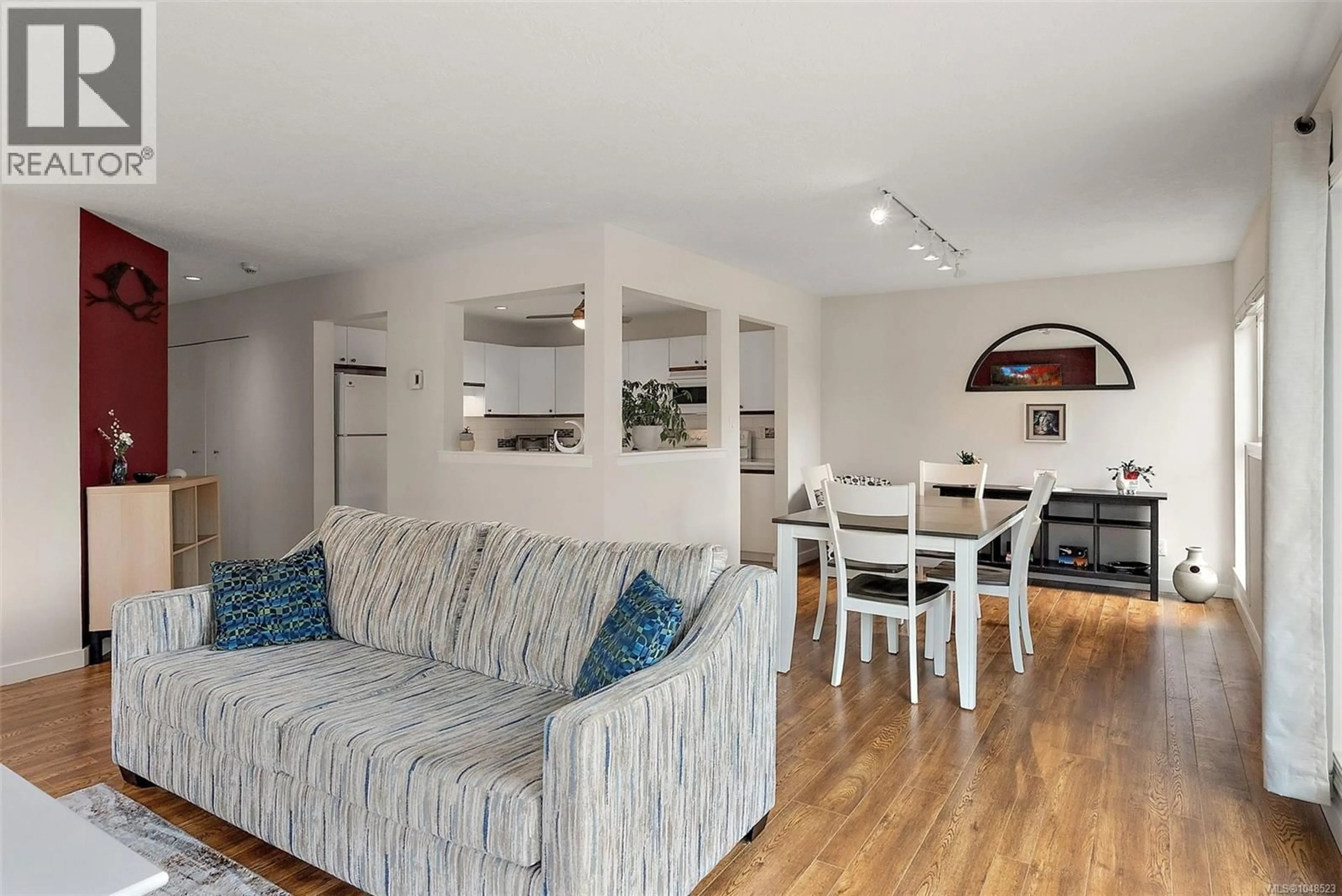 Living room with furniture, wood/laminate floor for 219 - 40 GORGE ROAD WEST, Saanich British Columbia V9A1L8