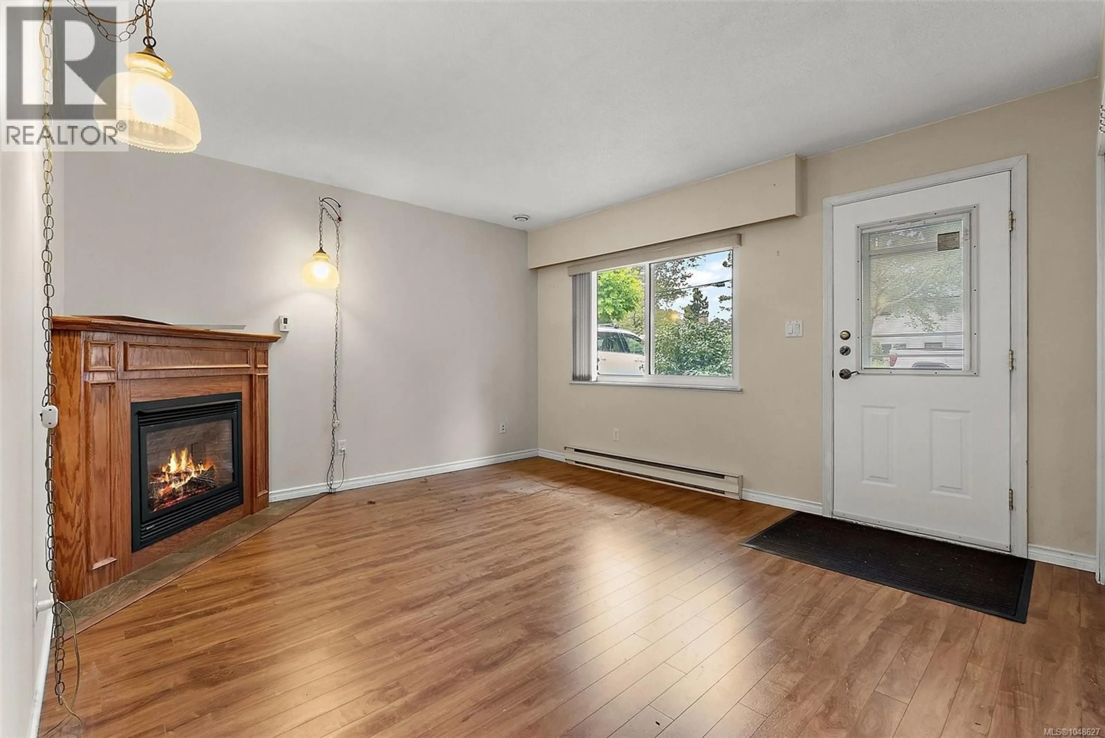 Living room with furniture, wood/laminate floor for 3167 IRMA STREET, Victoria British Columbia V9A1S9
