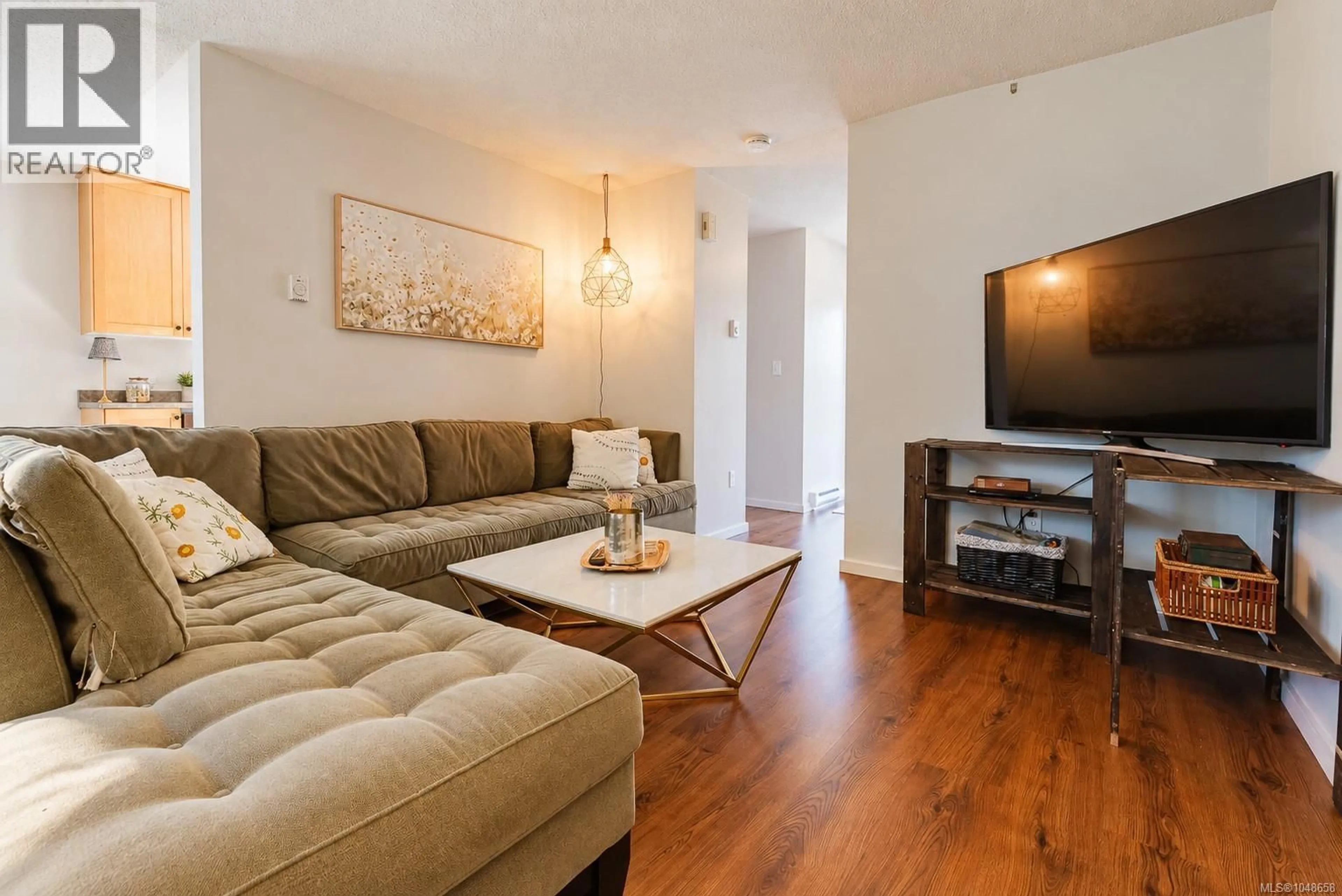 Living room with furniture, wood/laminate floor for 3035 METCHOSIN ROAD, Colwood British Columbia V9B4Y6